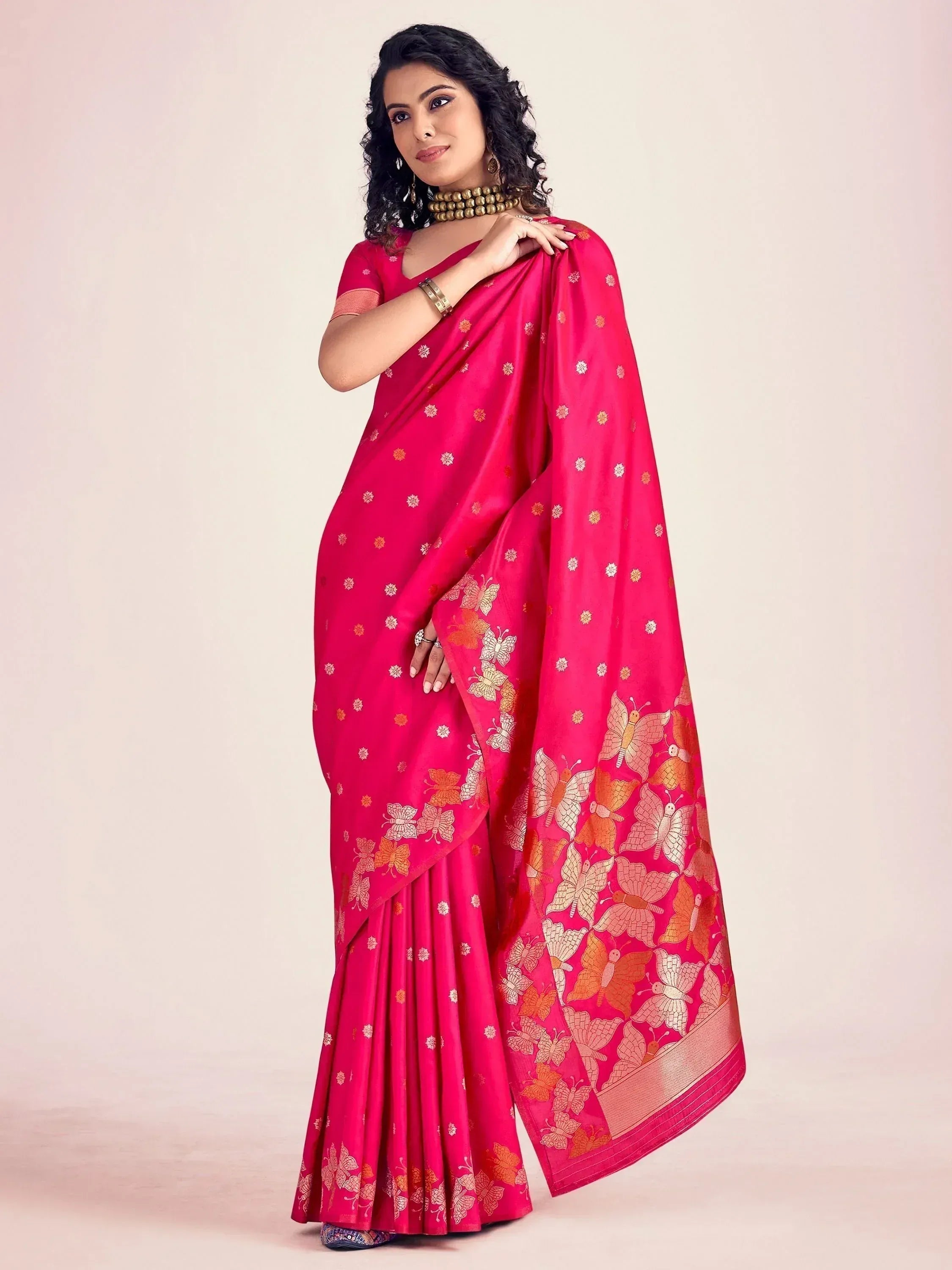Vibrant pink saree with golden butterfly print, perfect for Indian ethnic occasions and festive wear.