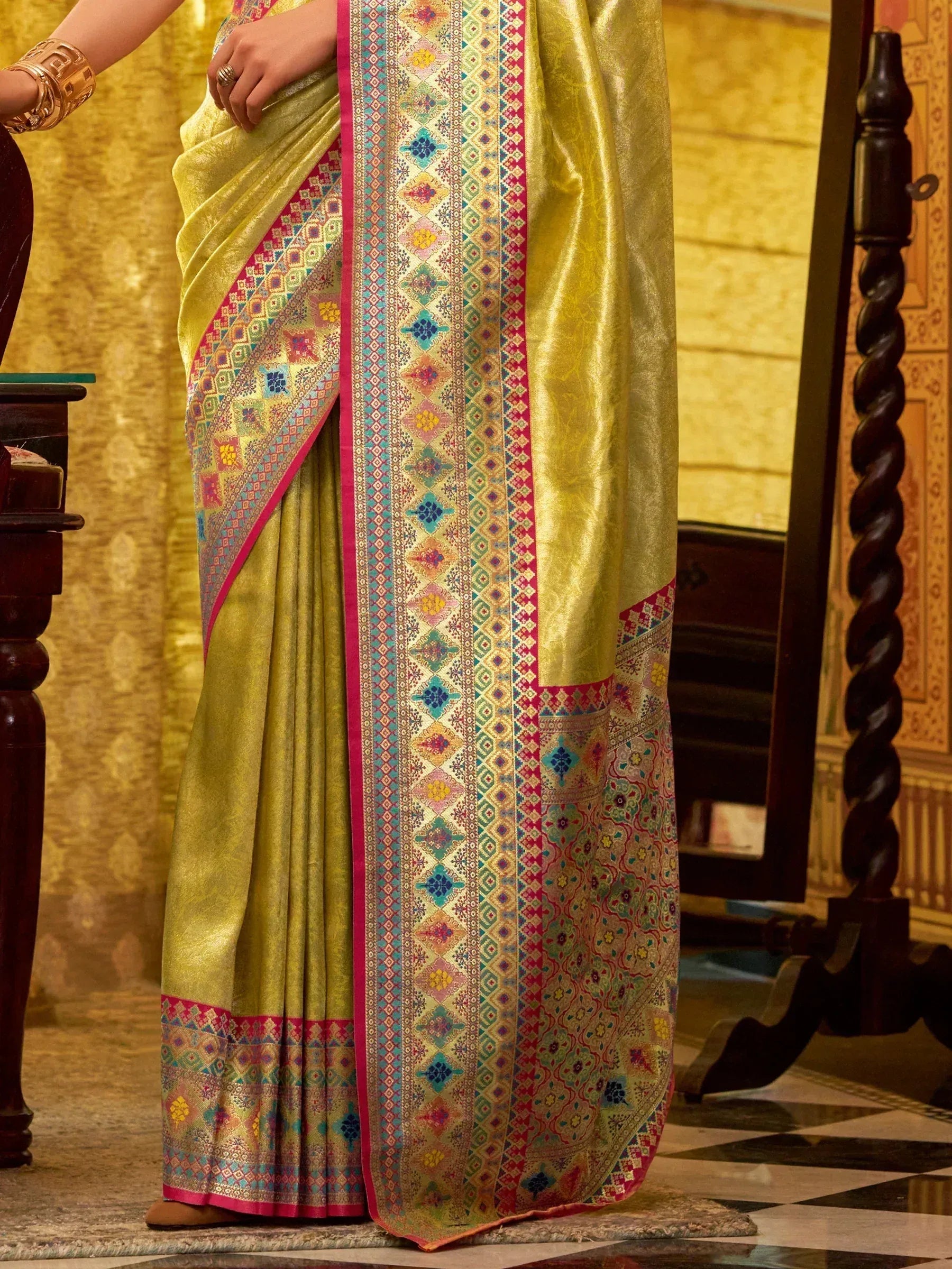 Golden saree with colorful geometric border, perfect for ethnic wear occasions