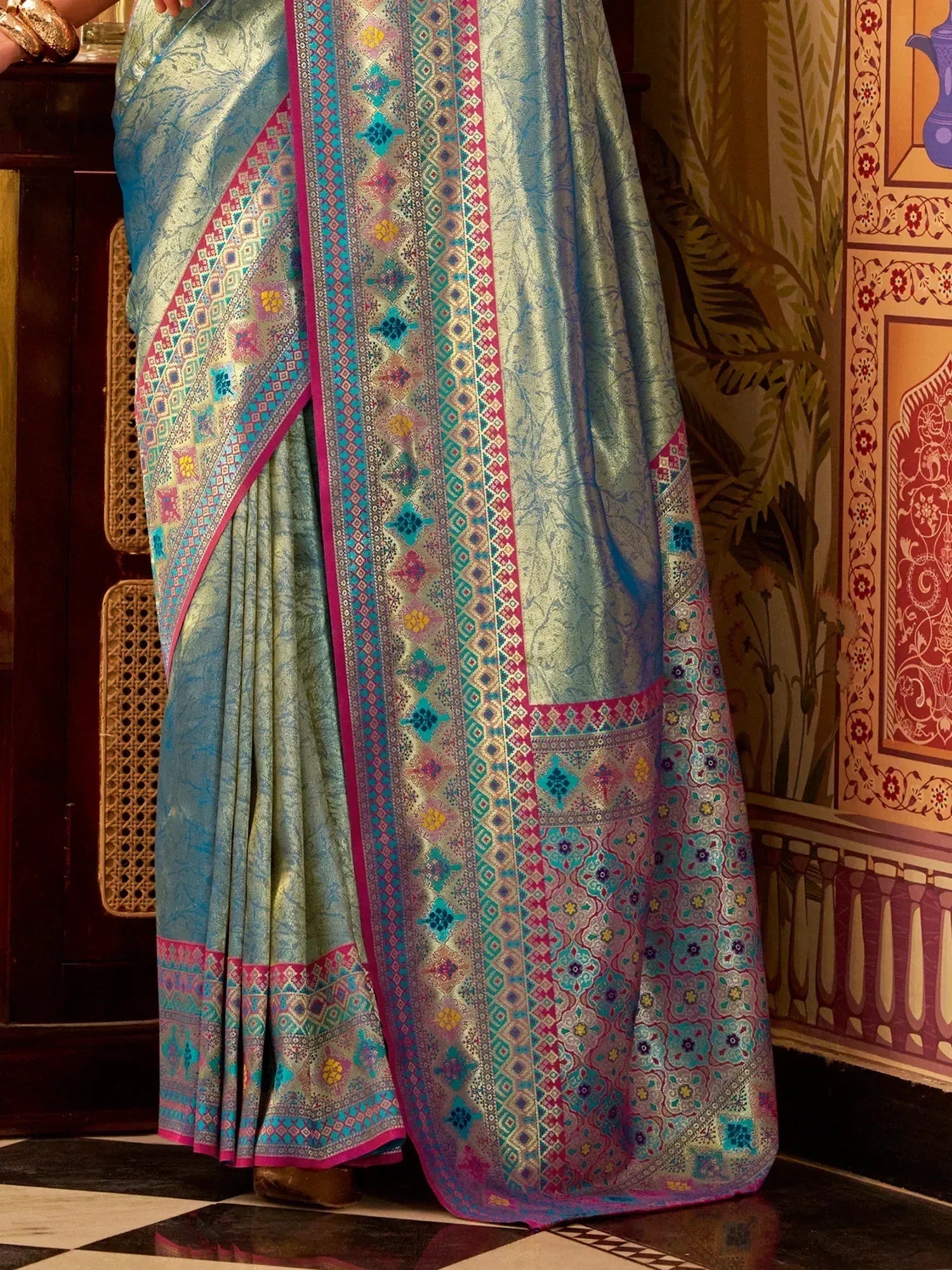 Elegant turquoise saree with intricate geometric and floral patterns, perfect for Indian ethnic wear.