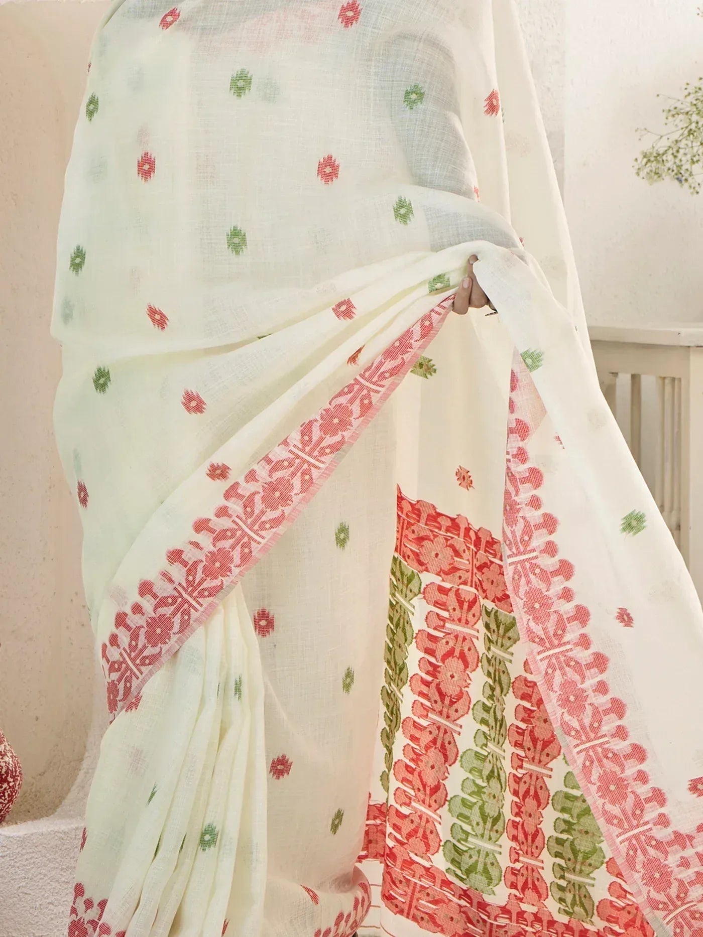 White ethnic saree with red and green floral block print, perfect for Indian occasions