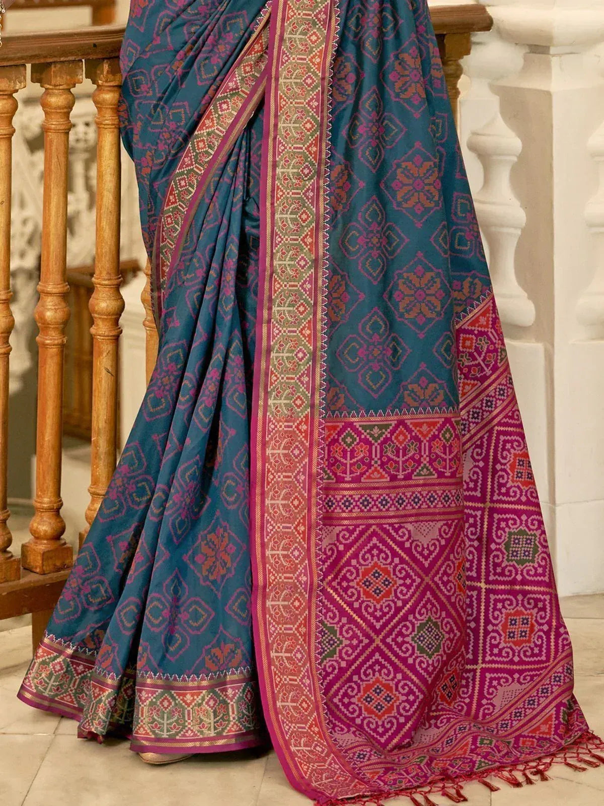 Teal and magenta ethnic saree with intricate geometric patterns and woven border, ideal for Indian occasions