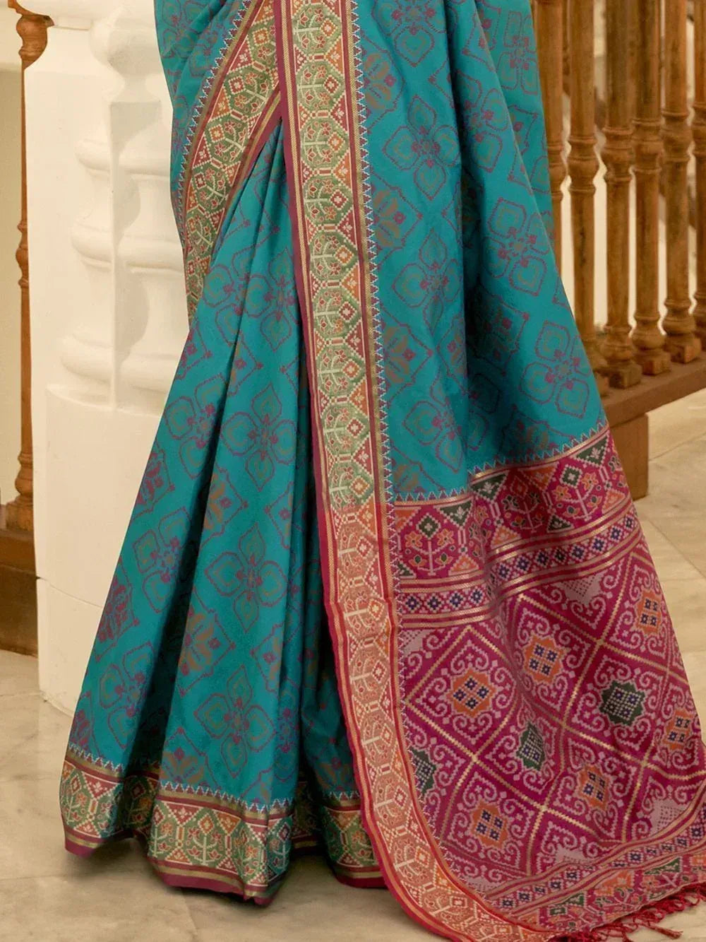 Teal and magenta ethnic saree with intricate geometric border, perfect for Indian festive wear
