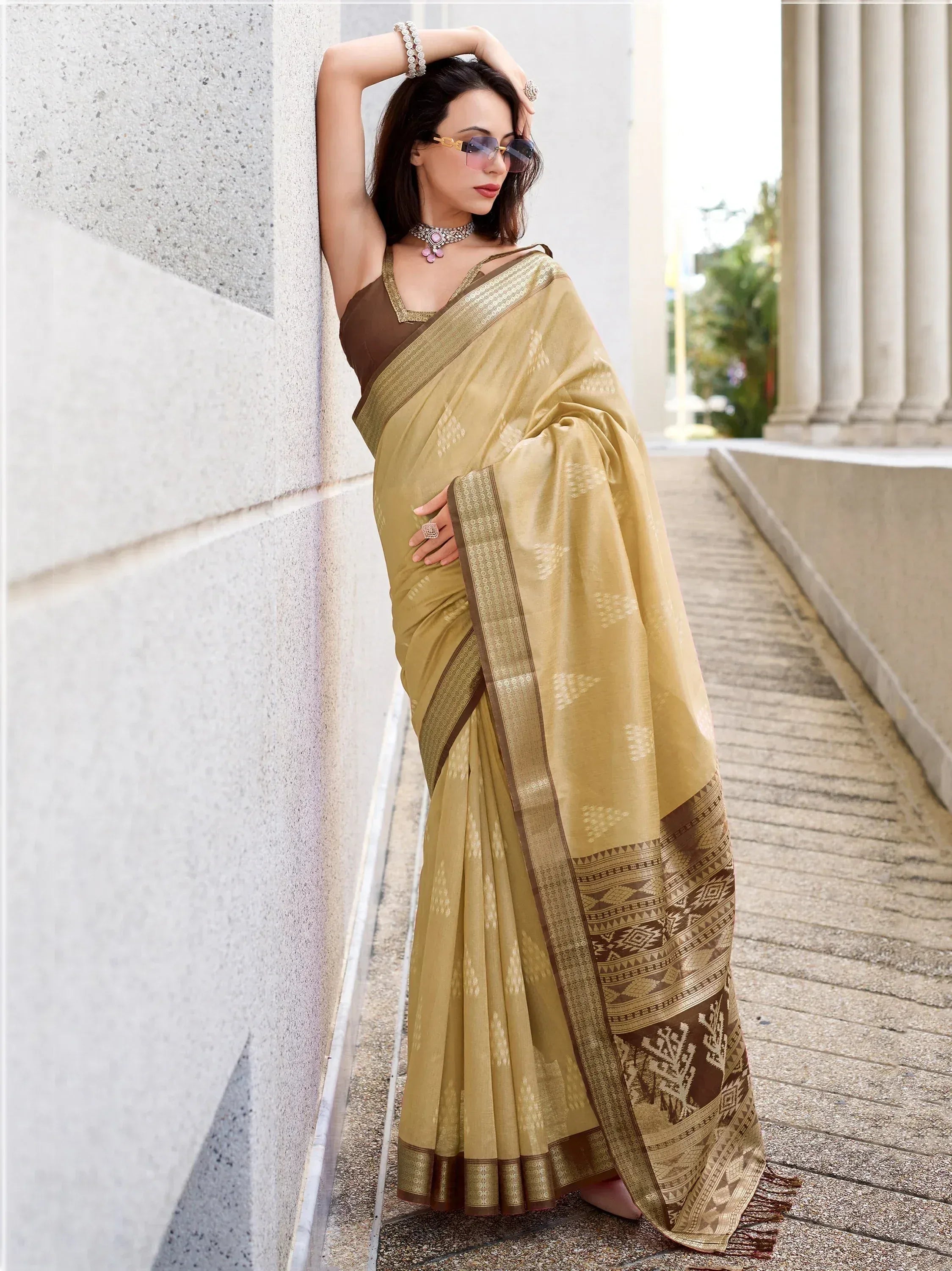 Woman in olive green designer saree with brown border, ethnic wear for festive occasions