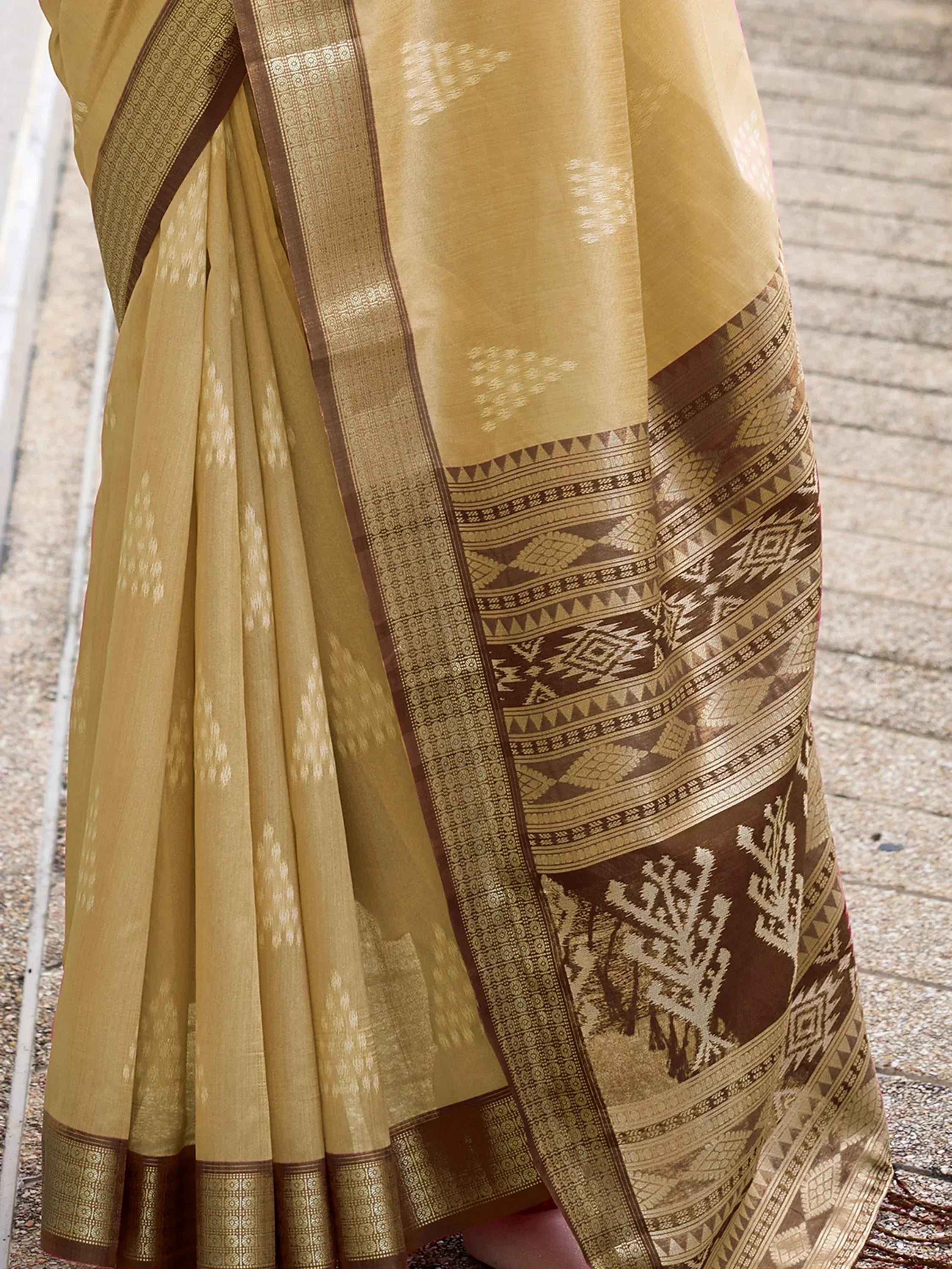 Mustard yellow ethnic saree with brown geometric border and ikat pattern, perfect for Indian occasions