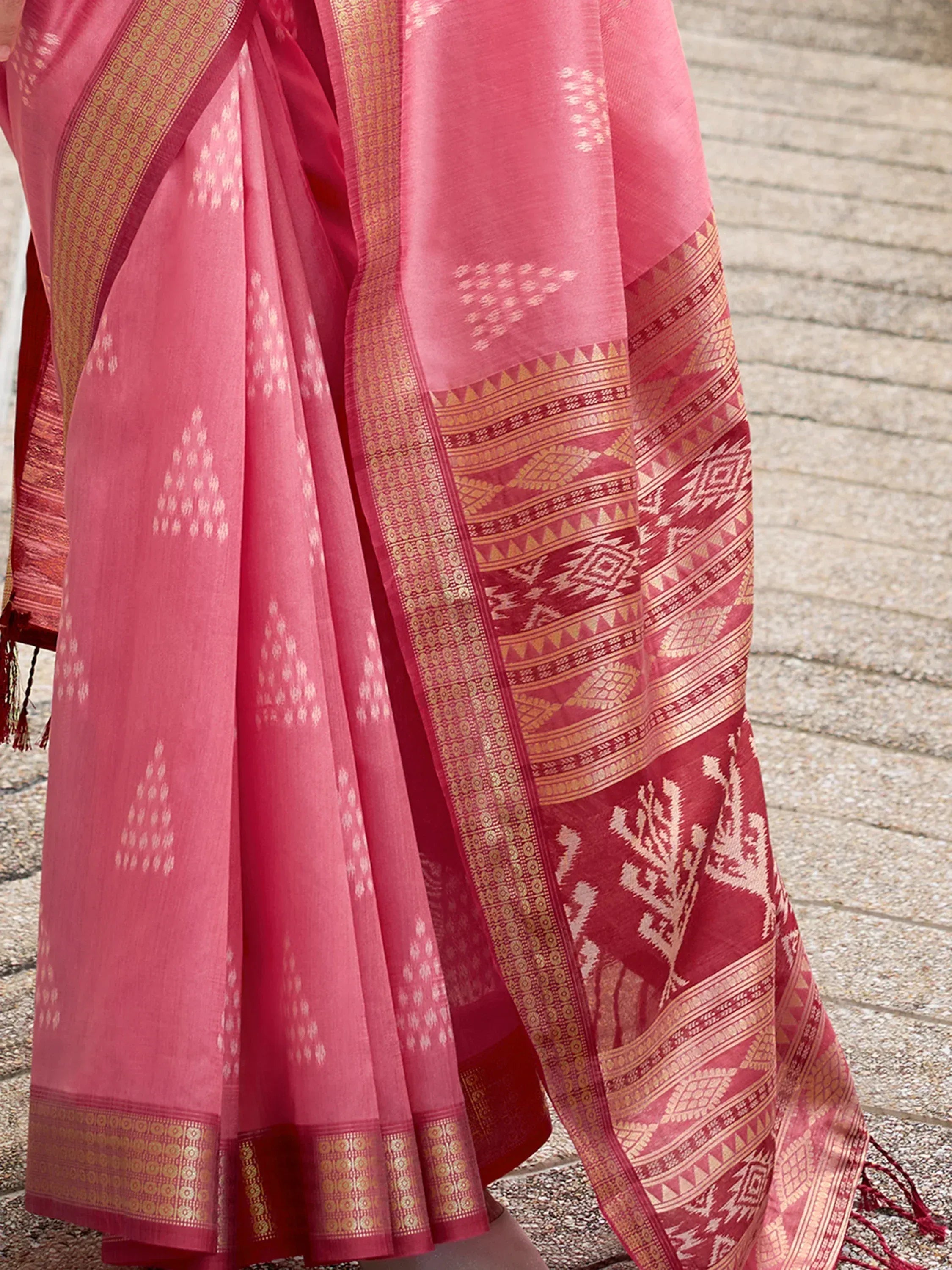 Pink ethnic saree with gold border and traditional woven patterns, perfect for Indian occasions