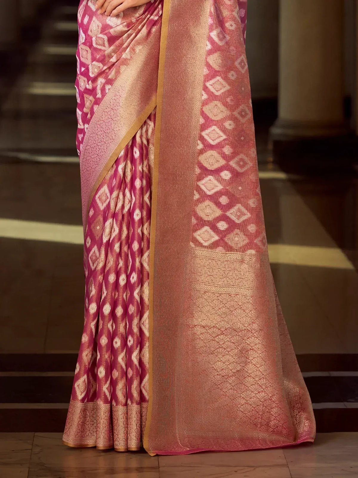 Pink and gold ikat patterned saree with intricate geometric design, perfect for ethnic occasions