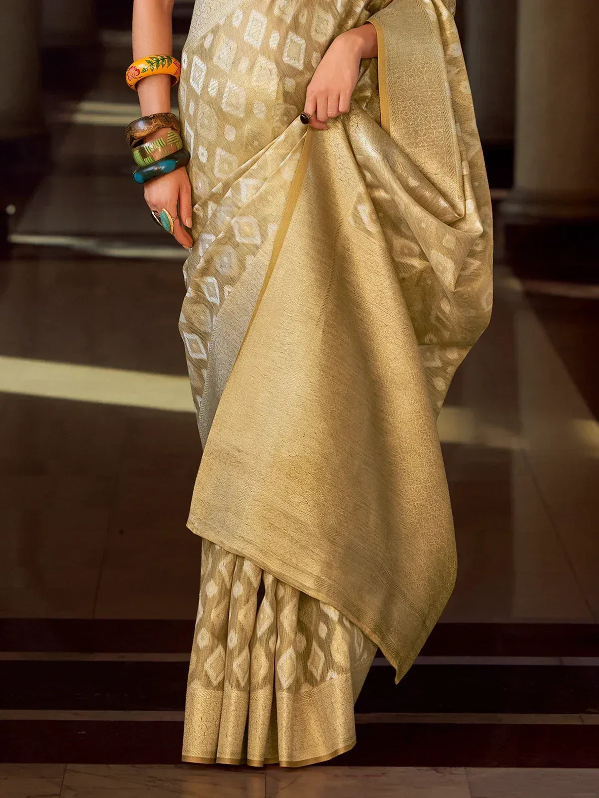 Elegant gold saree with geometric ikat pattern, perfect for Indian ethnic wear and festive occasions.