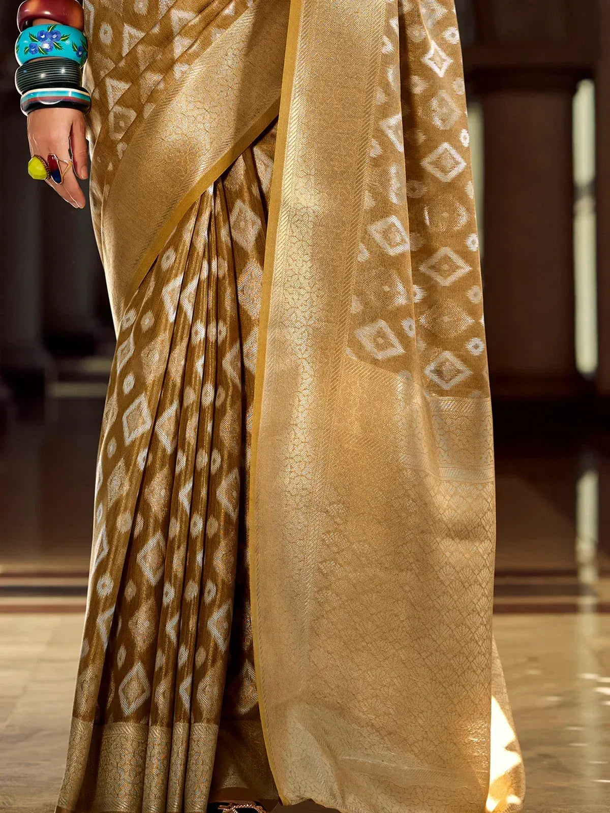 Golden ethnic saree with white geometric print, perfect for Indian occasions and festive wear.