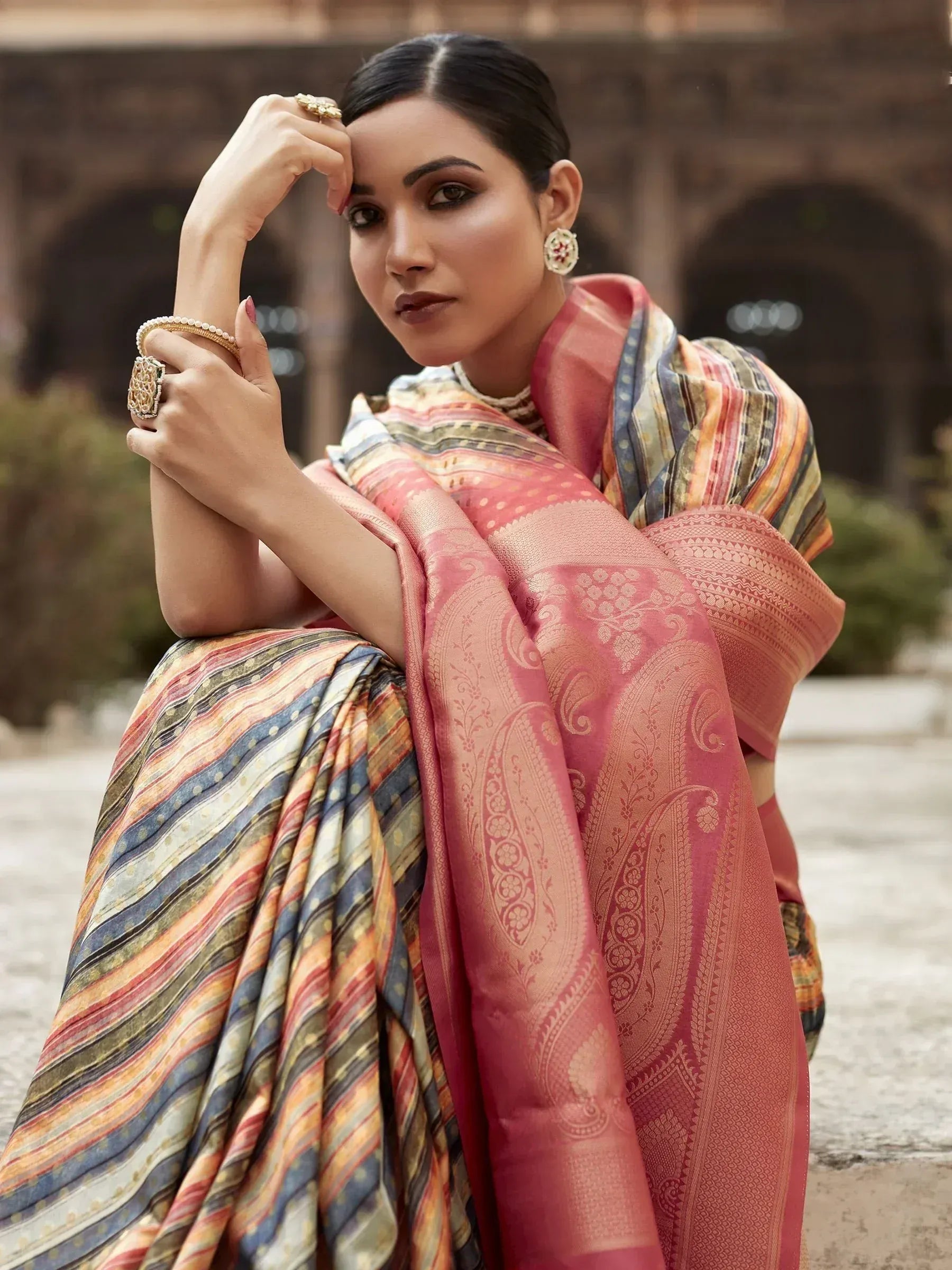 Woman in elegant pink and multicolor designer saree with paisley and striped patterns, traditional Indian ethnic wear