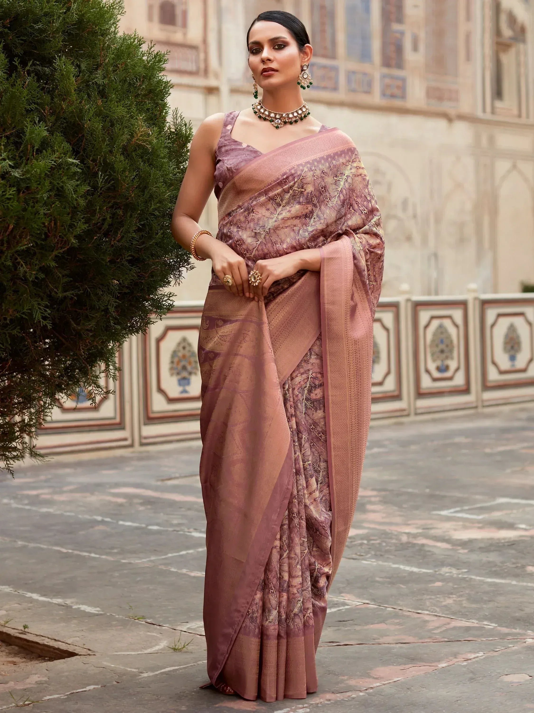 Woman in elegant mauve designer saree with gold leaf print, traditional Indian ethnic wear