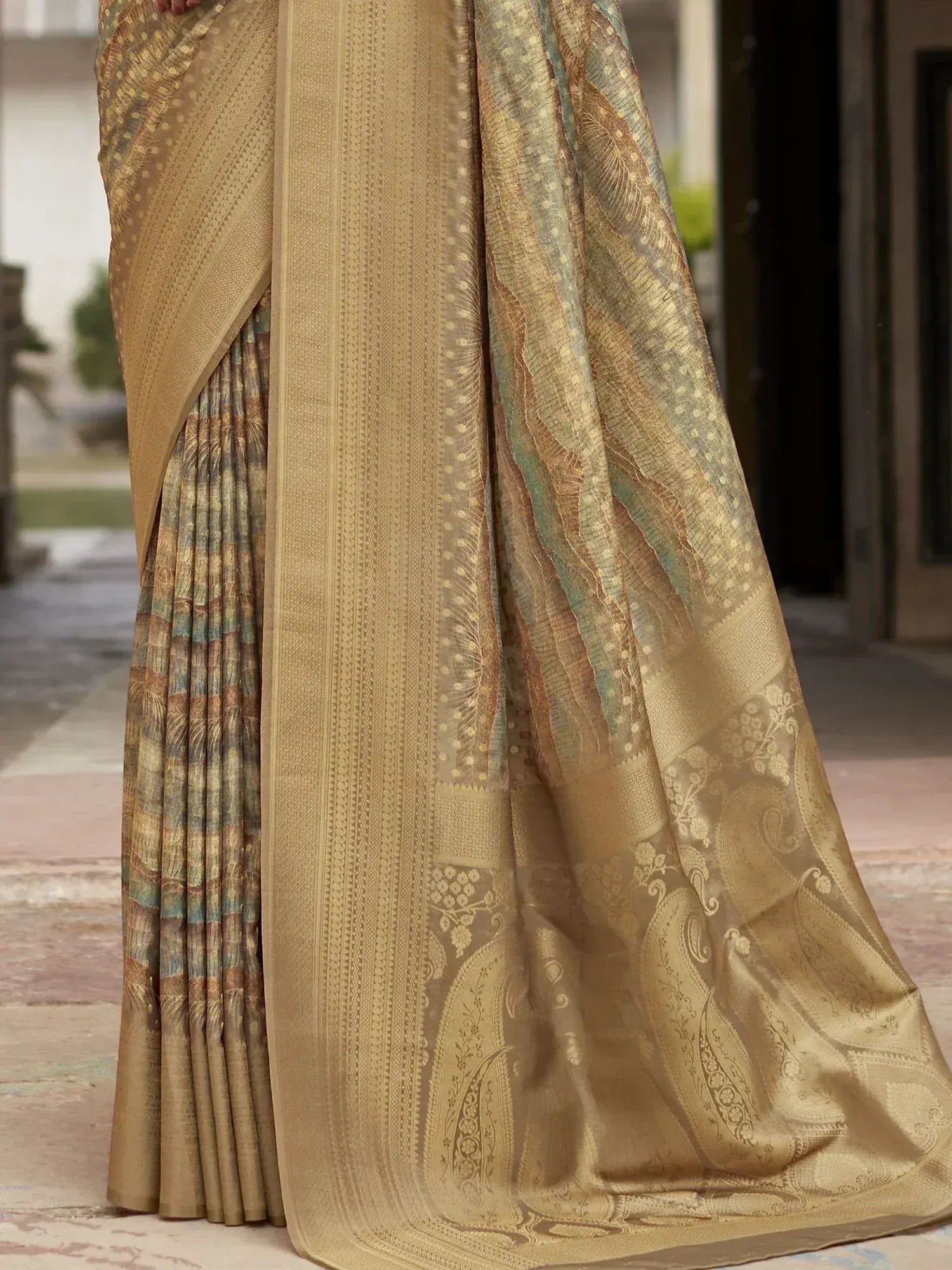 Elegant gold saree with intricate paisley and geometric patterns, perfect for ethnic occasions.