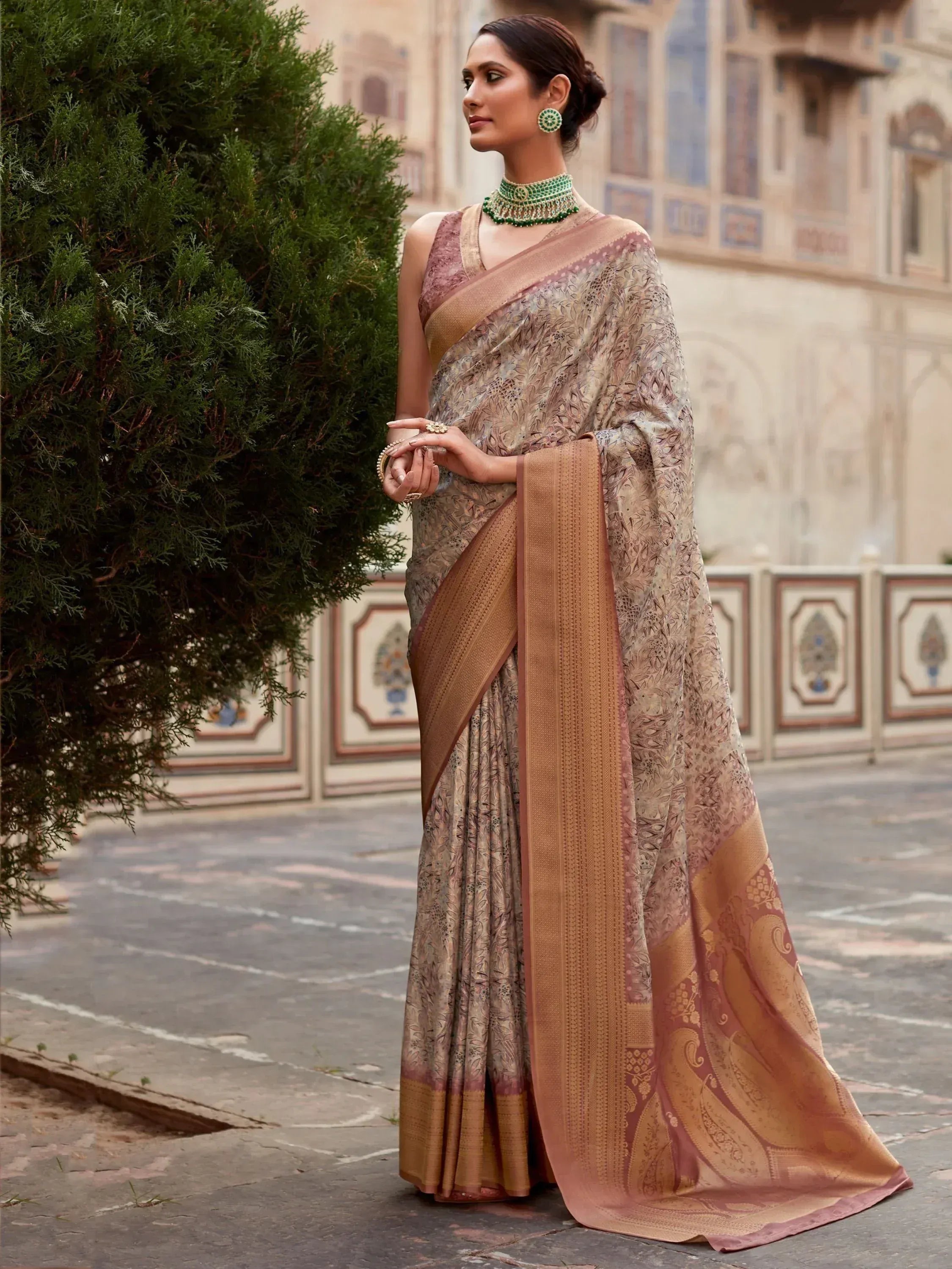 Elegant woman in designer saree with floral print and gold border, perfect for Indian ethnic wear occasions.