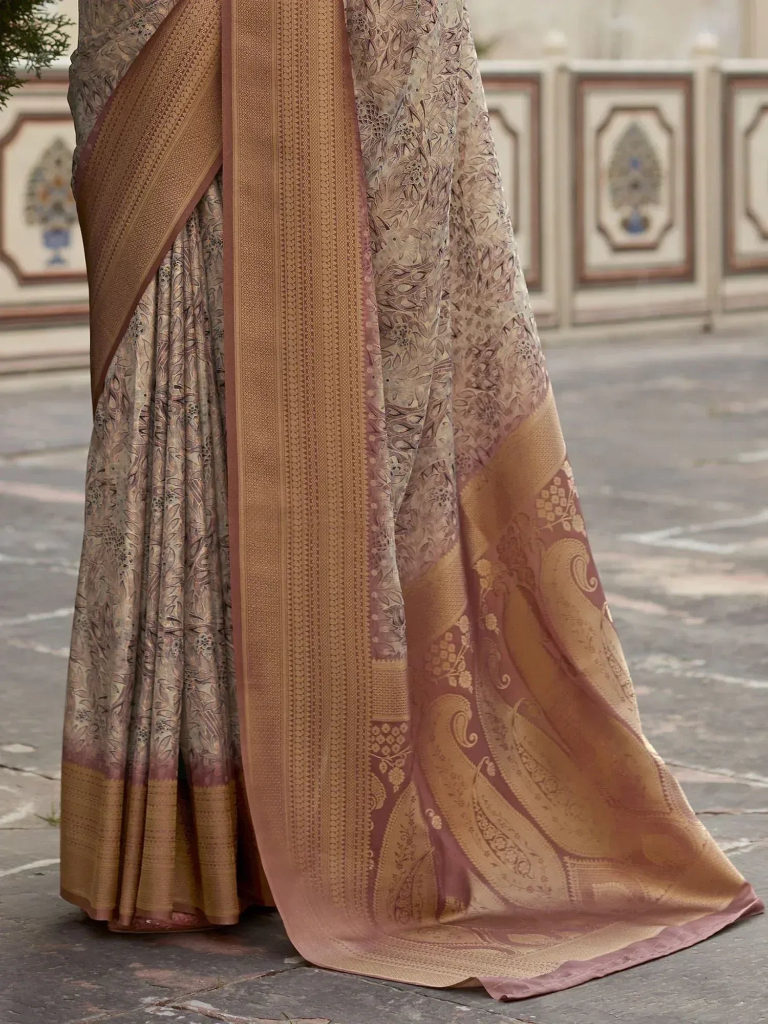 Elegant beige and gold floral saree with intricate paisley border, perfect for Indian ethnic occasions.