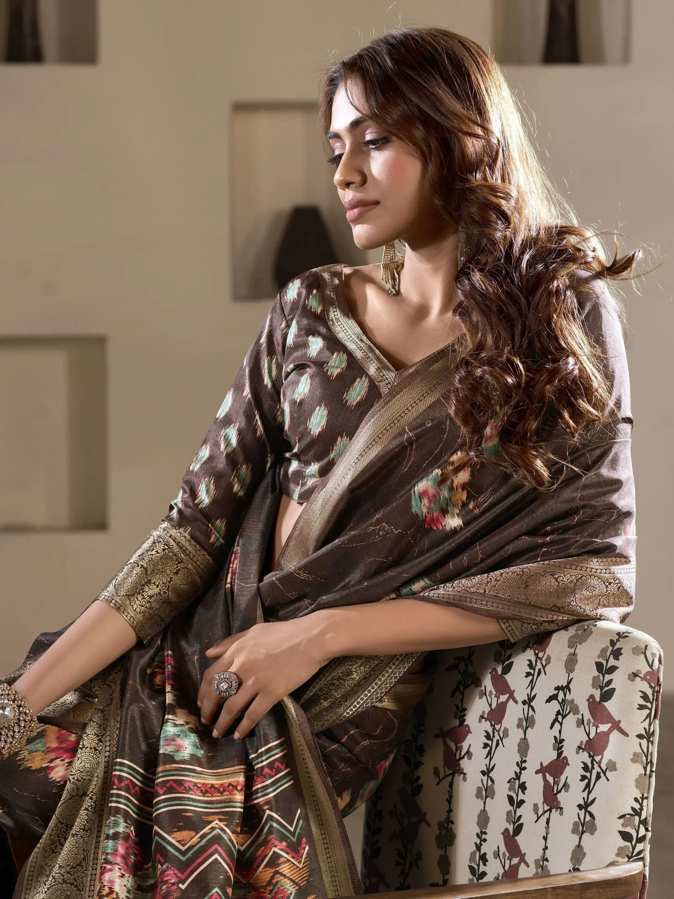 Elegant woman in brown printed saree with gold border, styled for Indian ethnic wear occasions