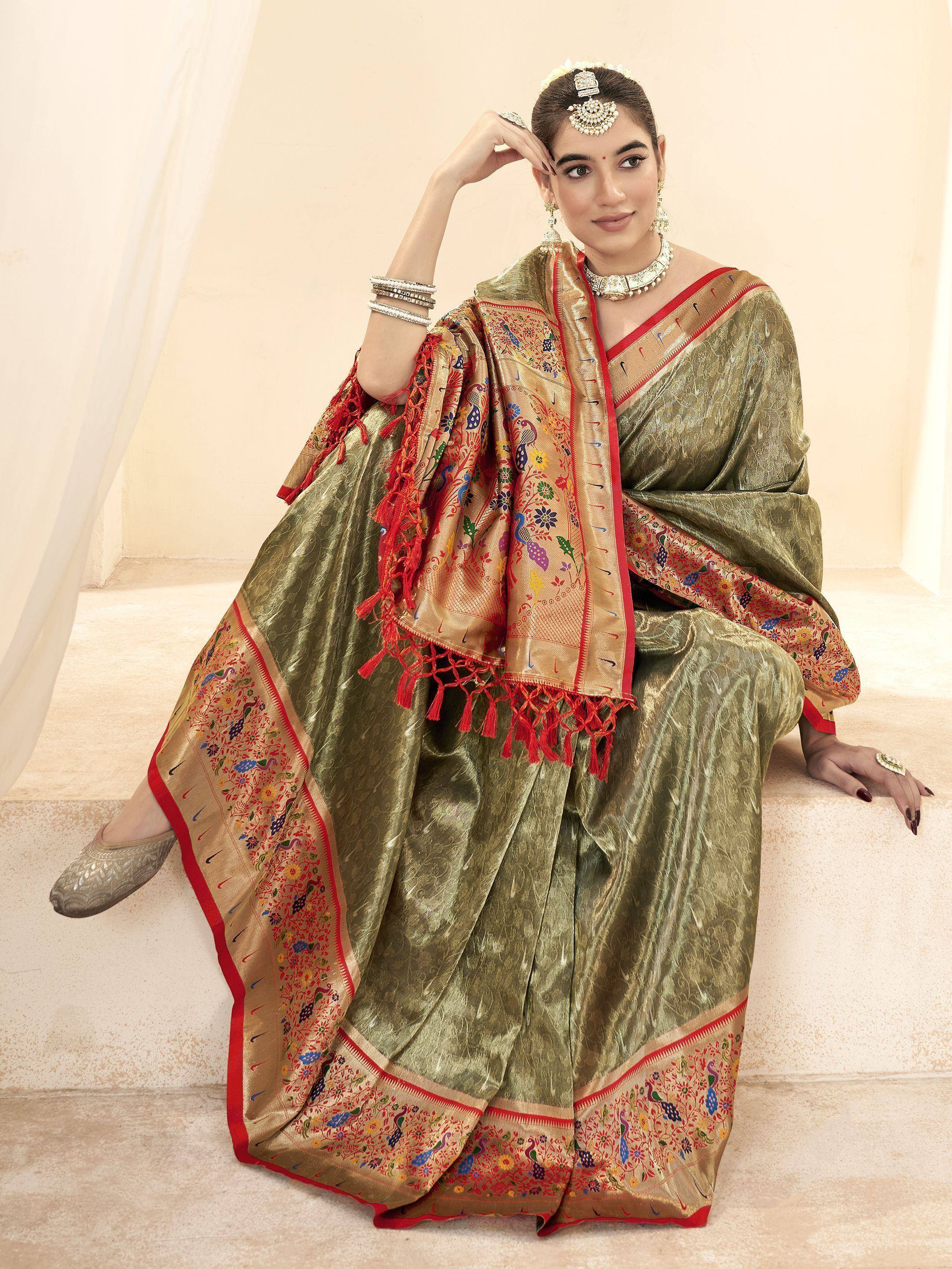 Olive green ethnic saree with peacock embroidery and red border, perfect for Indian weddings and festivals.