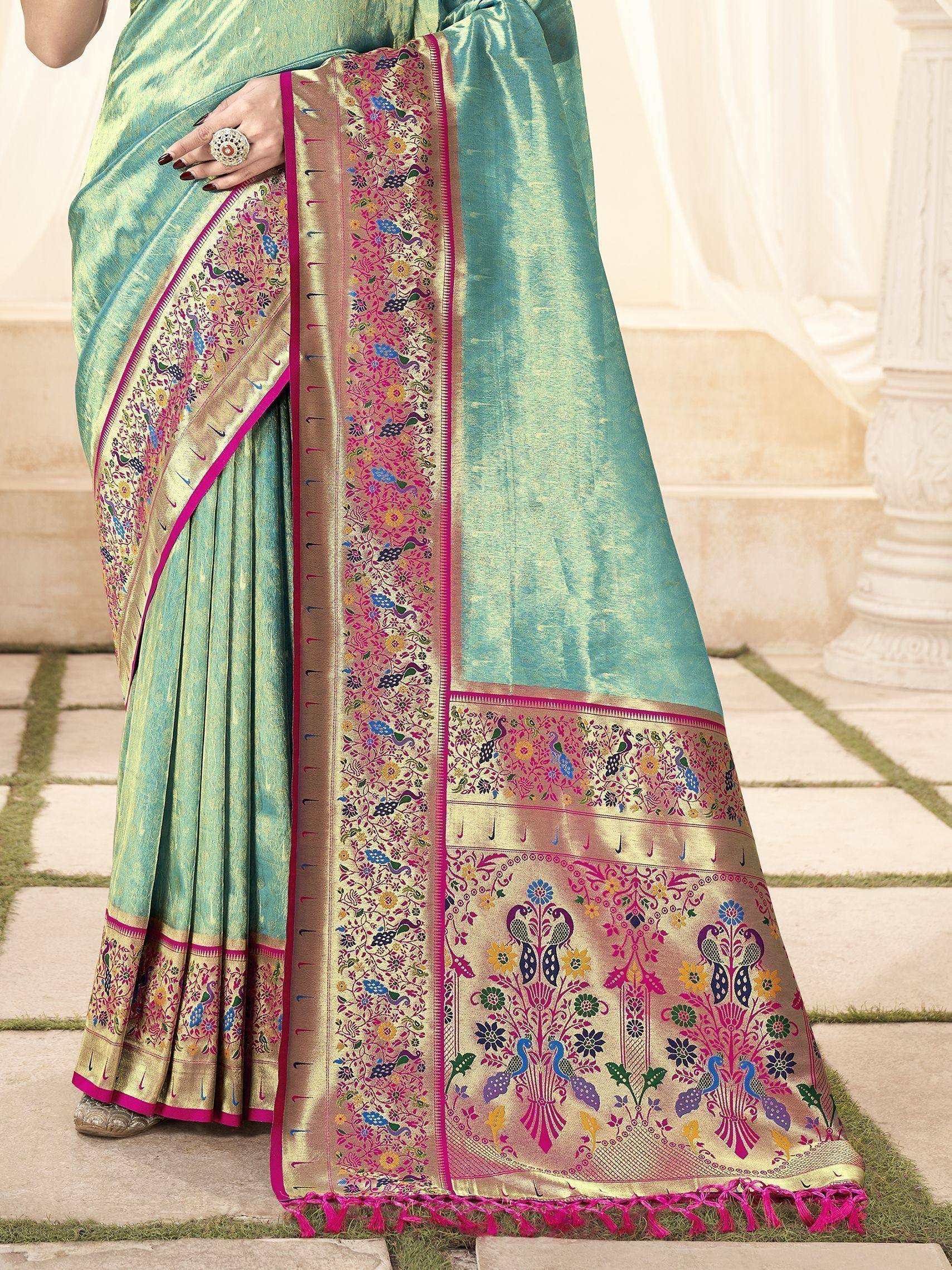 Teal silk saree with vibrant peacock and floral embroidery, perfect for Indian ethnic wear occasions.