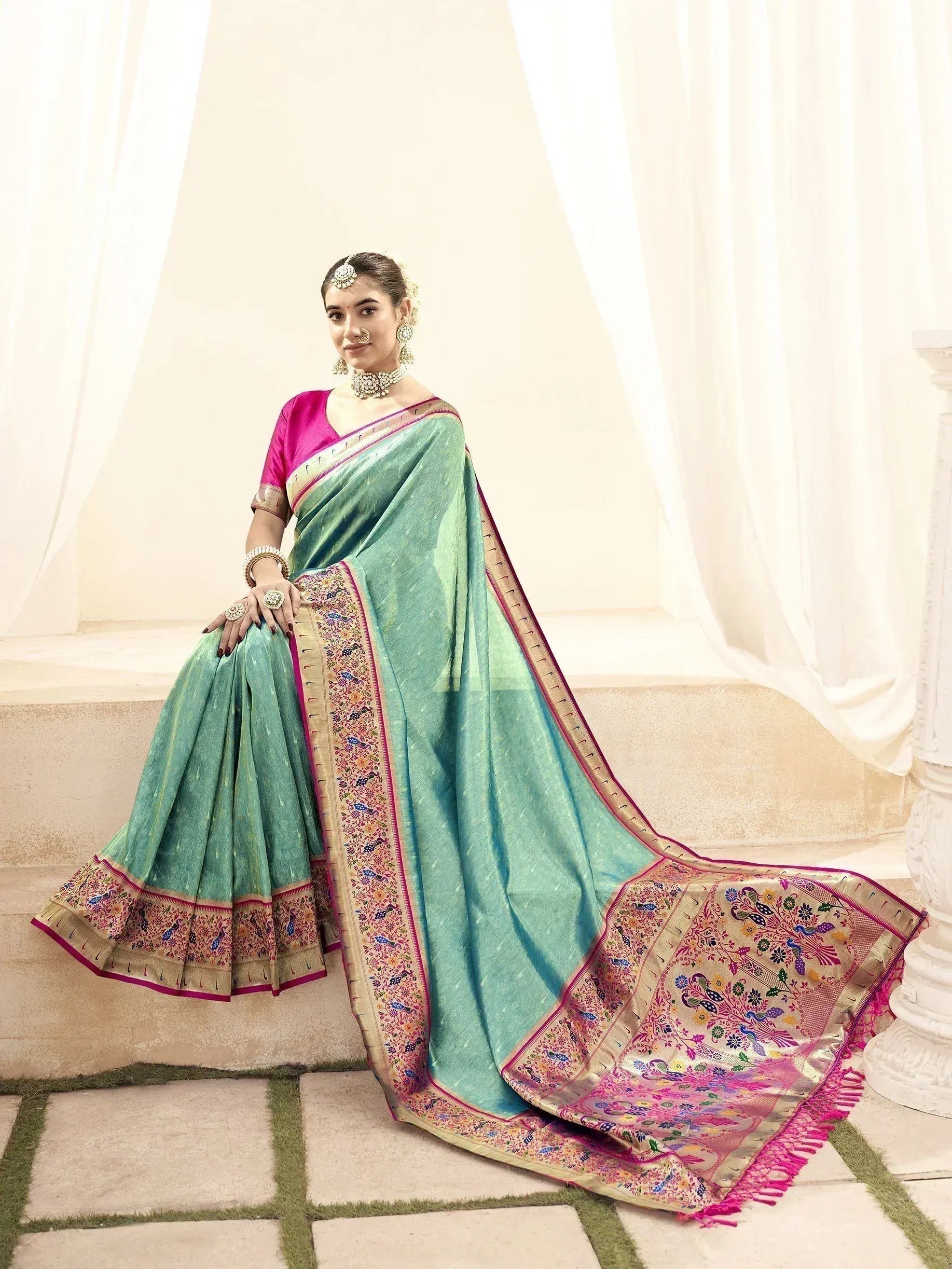 Elegant mint green saree with pink blouse and peacock embroidery, perfect for Indian ethnic wear occasions.