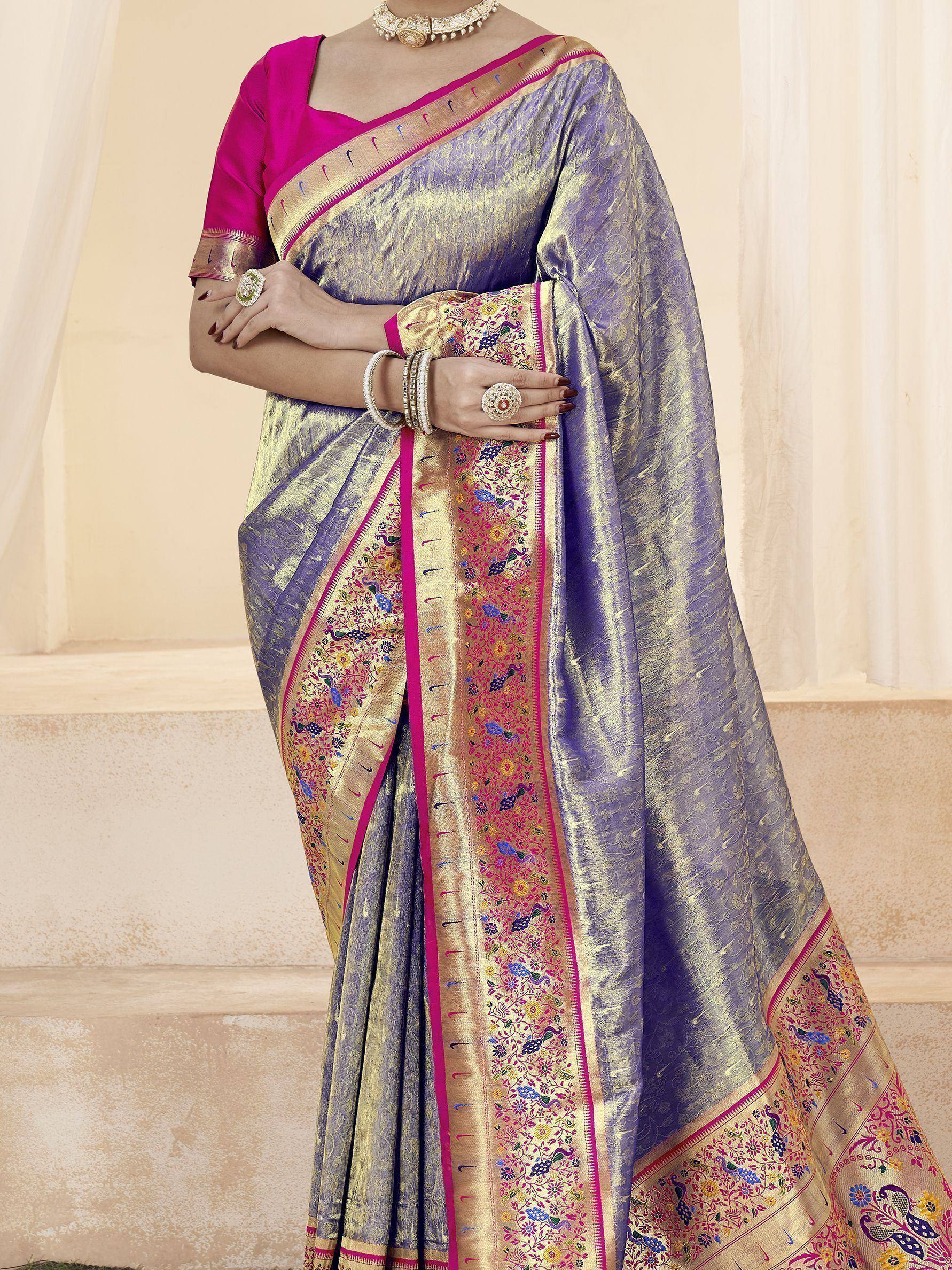Purple and gold designer saree with peacock embroidery, paired with pink blouse, perfect for Indian ethnic wear.