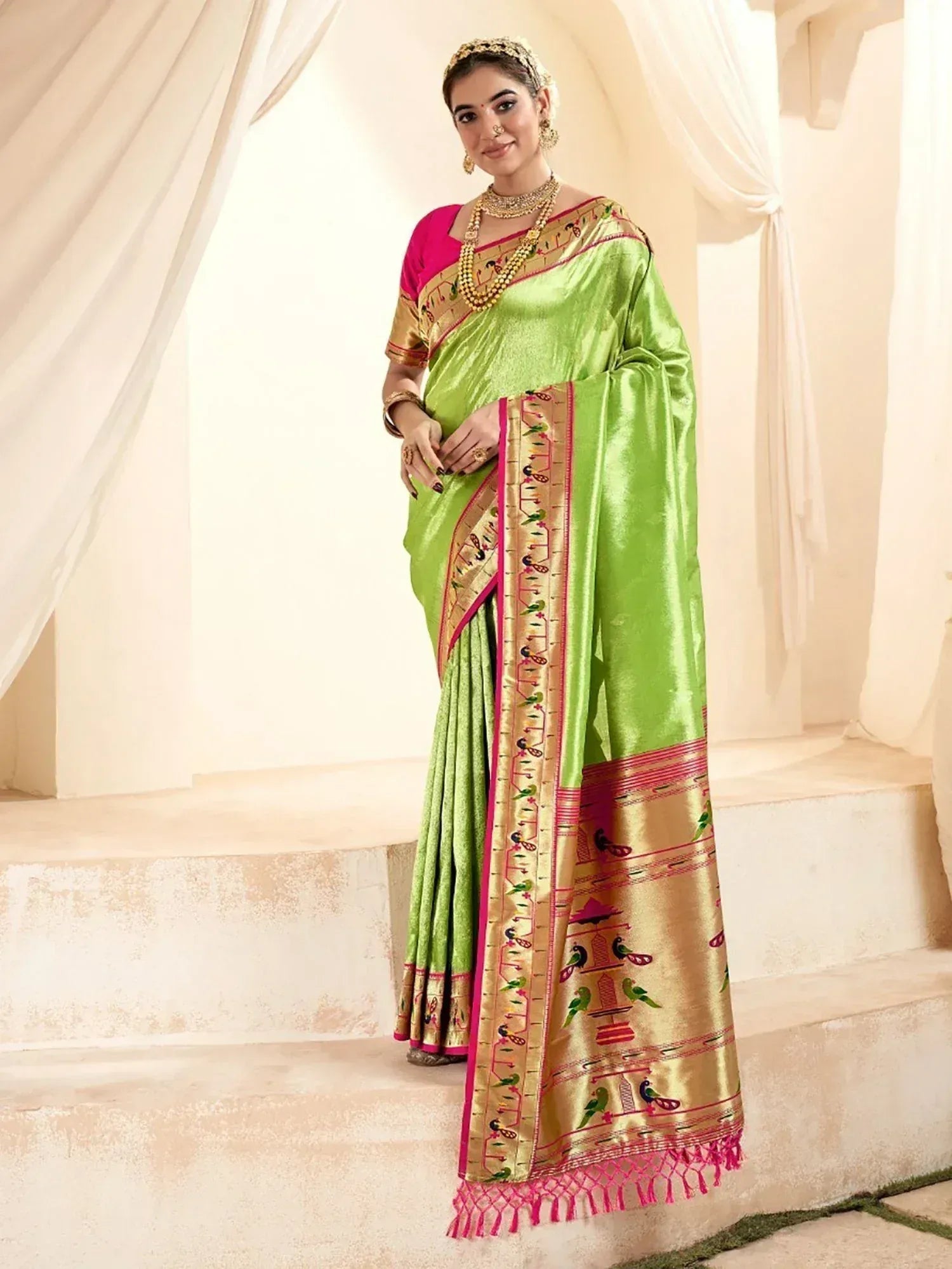 Lime green silk saree with gold bird motifs and pink border, paired with pink blouse, ideal for Indian ethnic occasions