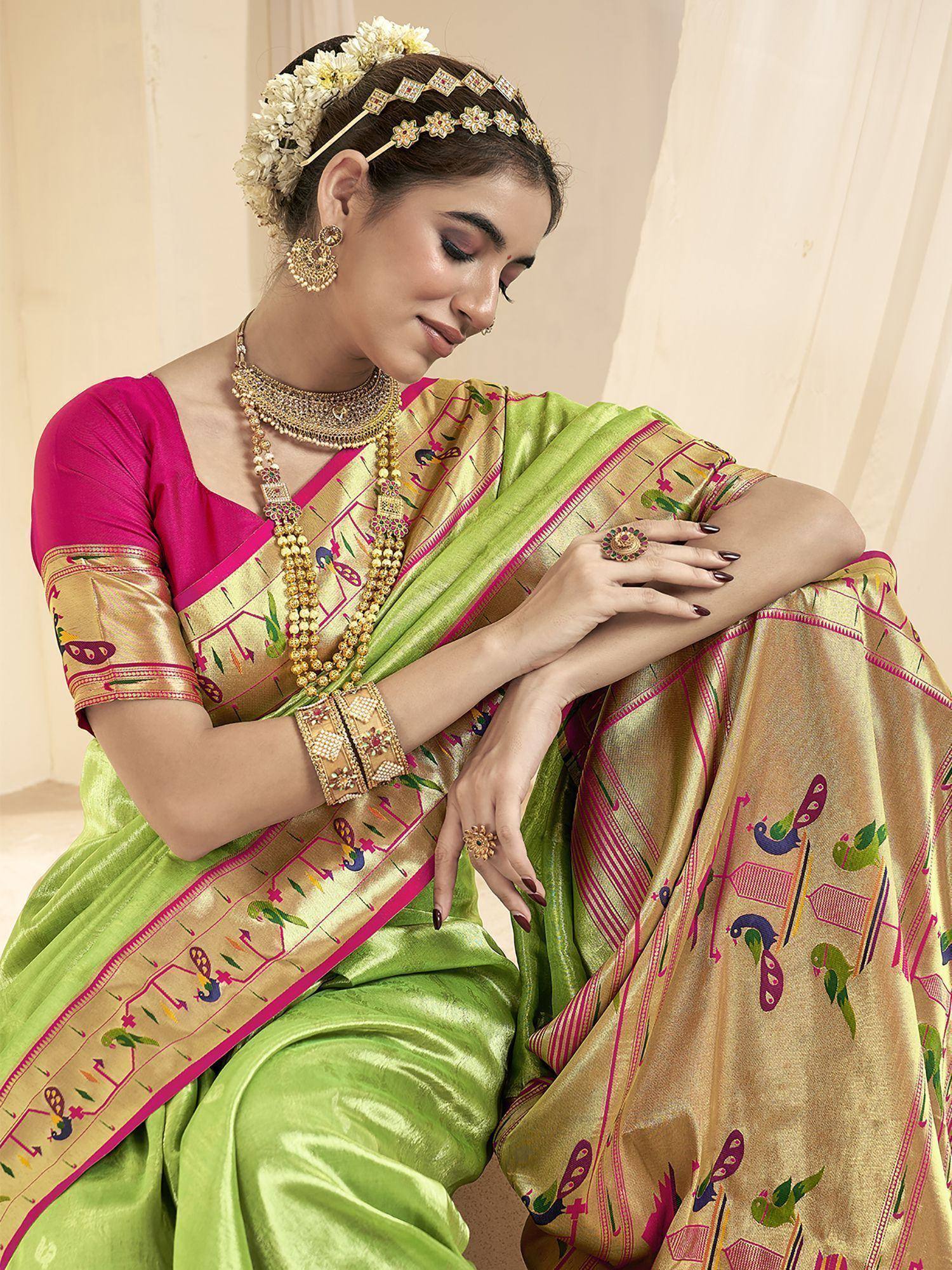 Green and gold embroidered saree with pink blouse, traditional Indian ethnic wear, floral hair accessory