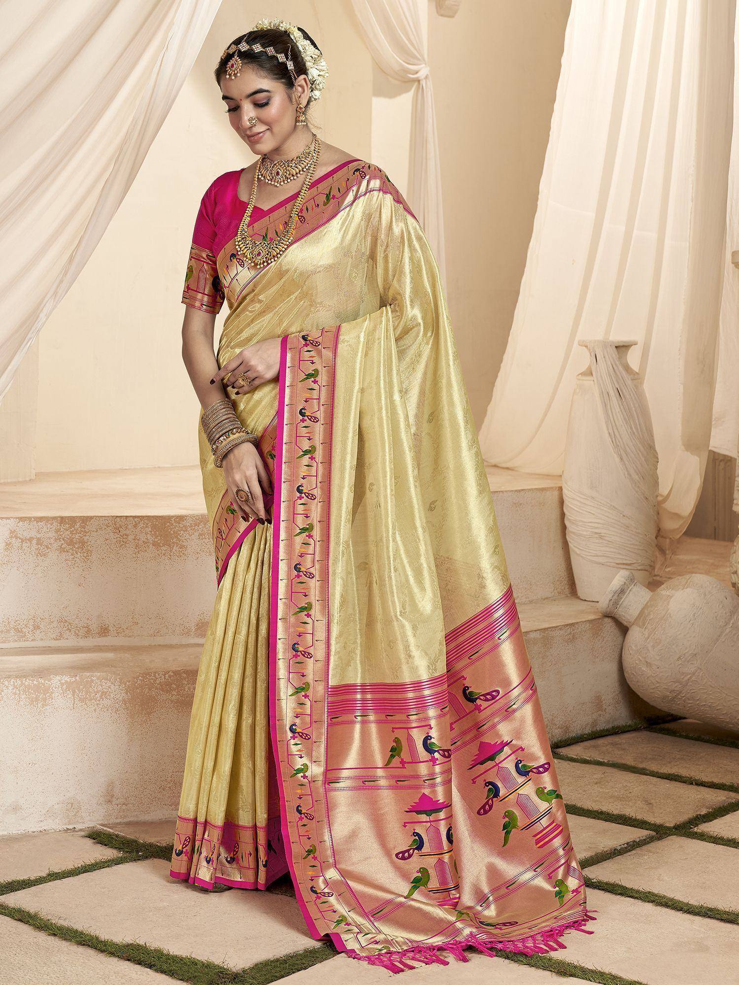 Elegant gold saree with pink border and bird motifs, paired with matching blouse, perfect for Indian ethnic occasions.