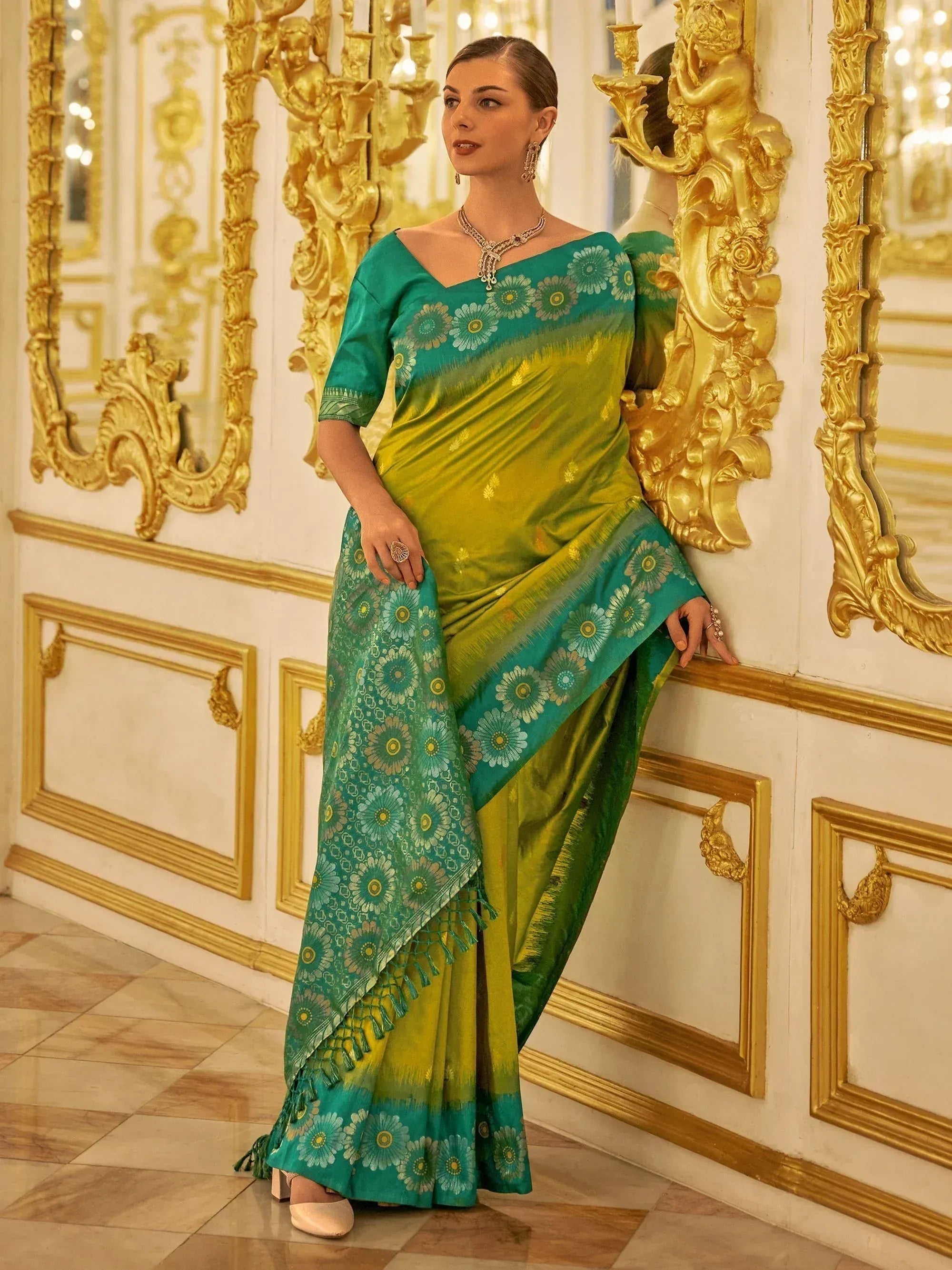Elegant green and teal floral saree with gold accents, perfect for Indian ethnic wear occasions
