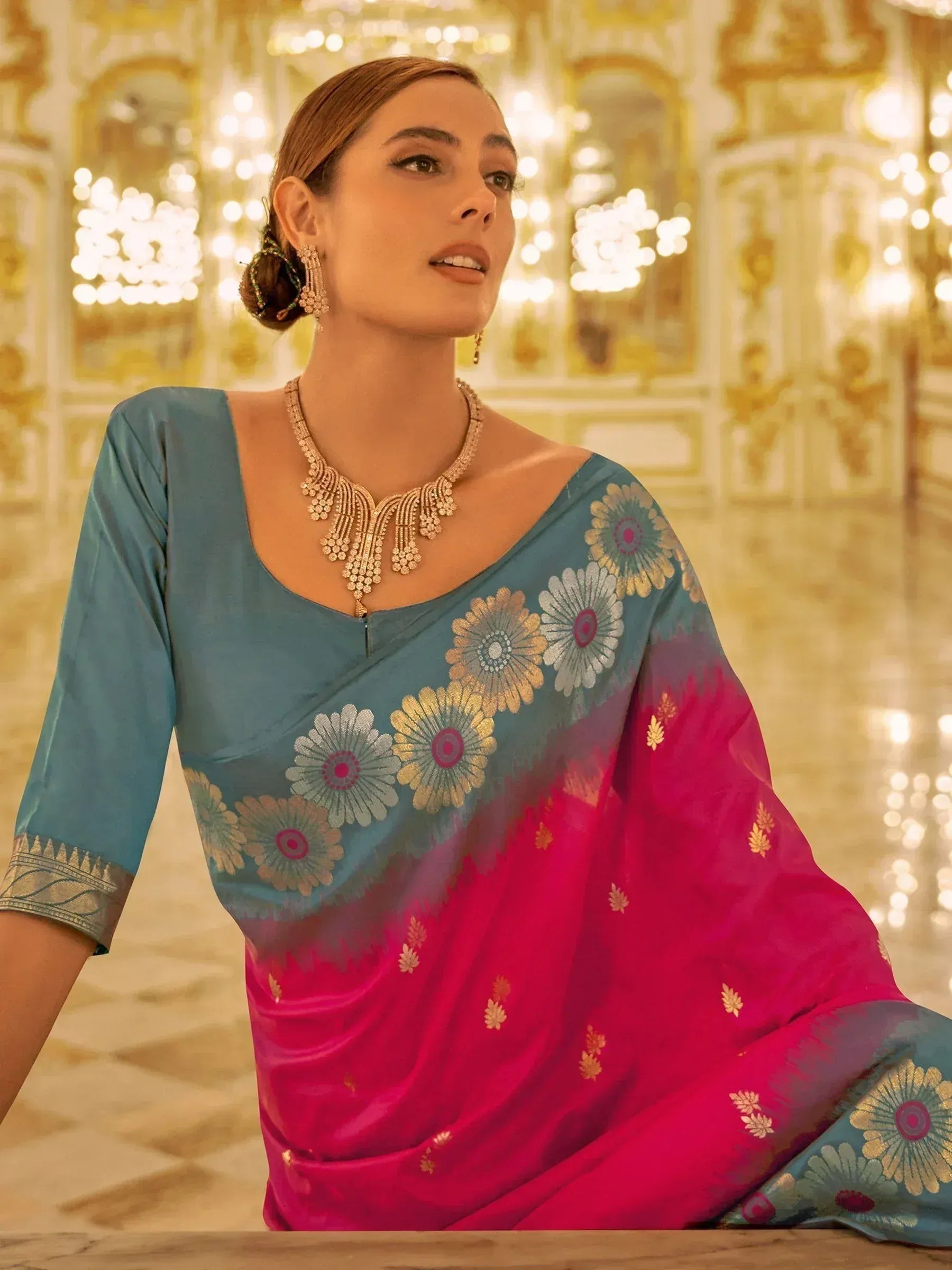 Blue and pink floral saree with gold embroidery, styled with statement jewelry for ethnic occasions