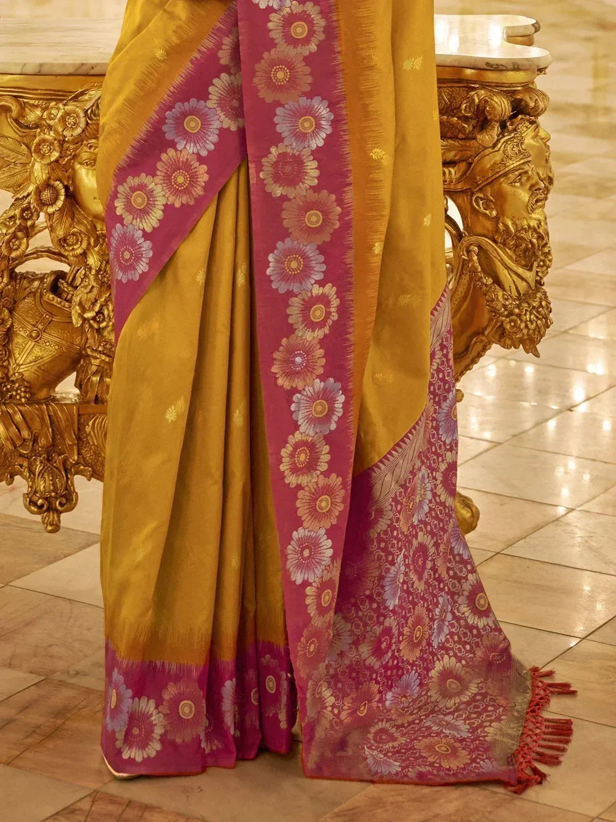 Golden and magenta floral saree with intricate border, elegant ethnic wear for festive occasions