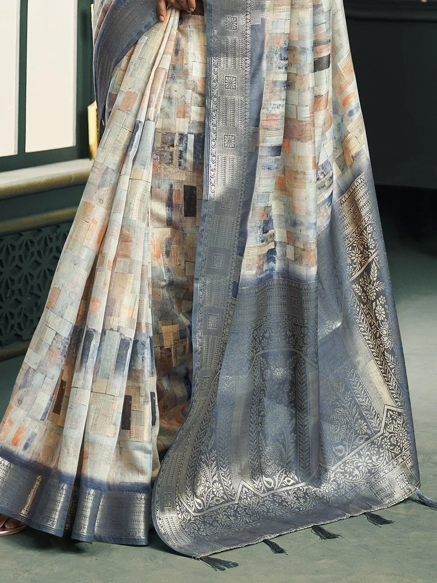 Elegant Indian saree with patchwork print and intricate silver border, perfect for ethnic occasions.