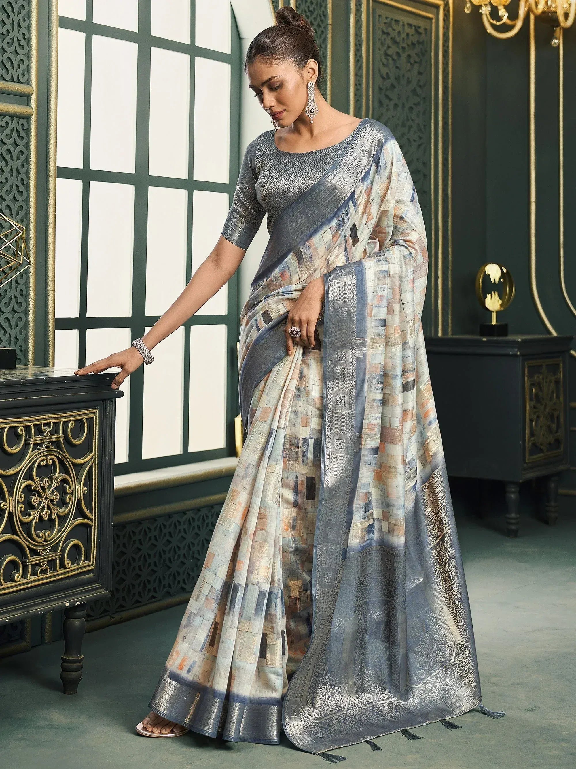 Woman in elegant printed saree with silver border, designer ethnic wear for festive occasions