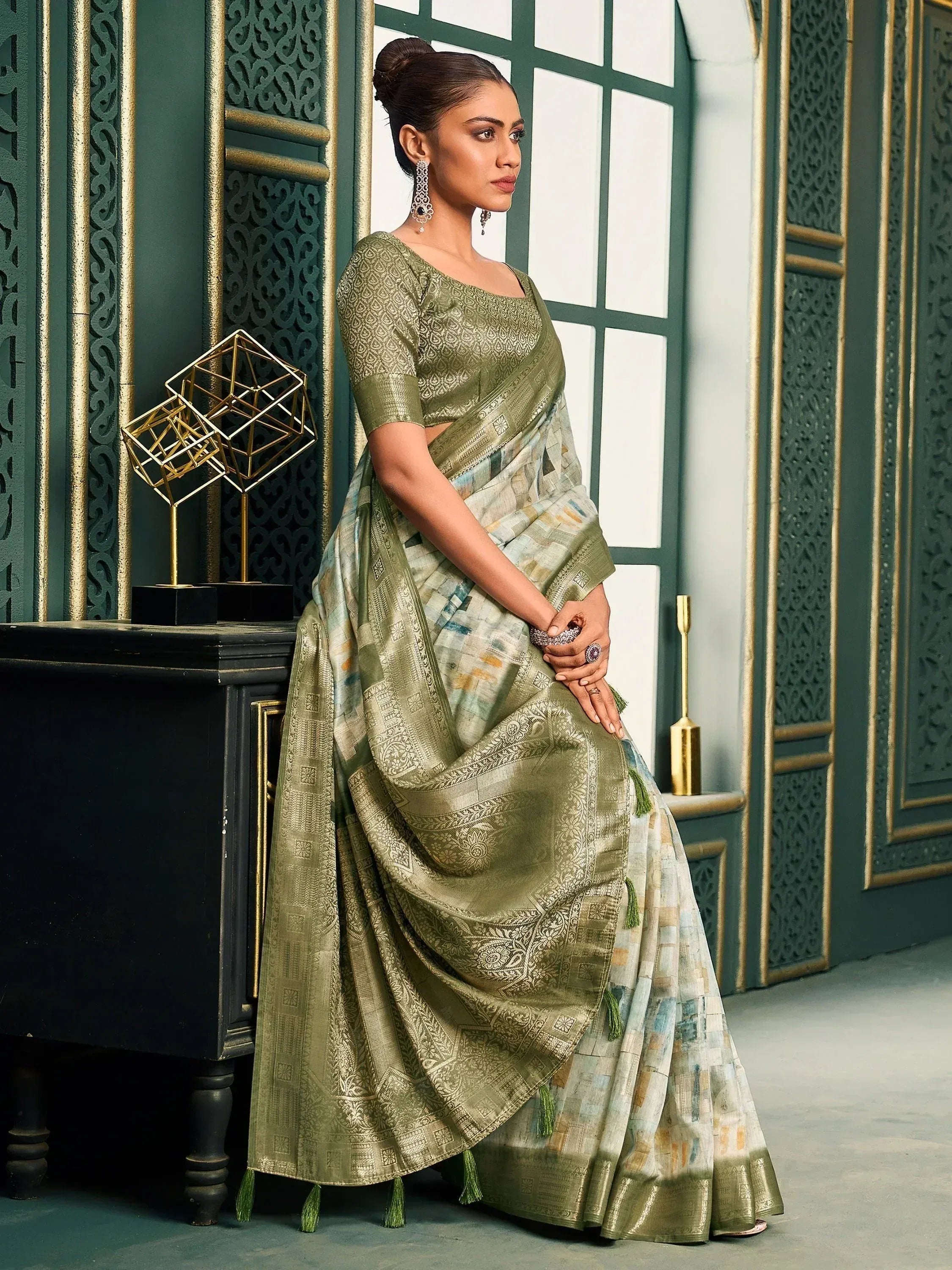Olive green designer saree with gold embroidery and tassels, perfect for Indian ethnic wear occasions.