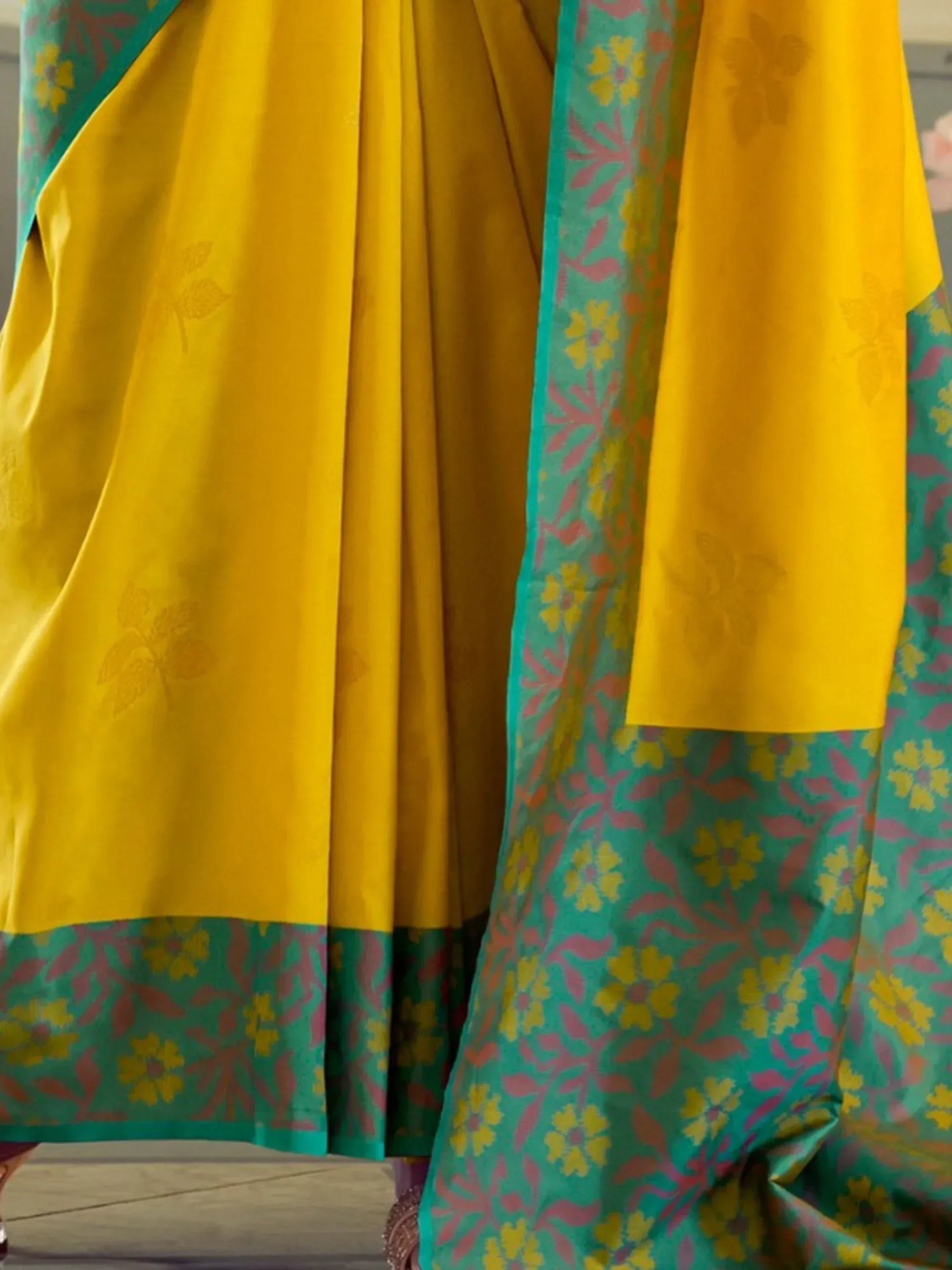 Vibrant yellow and teal floral printed Indian ethnic wear with contrasting border details
