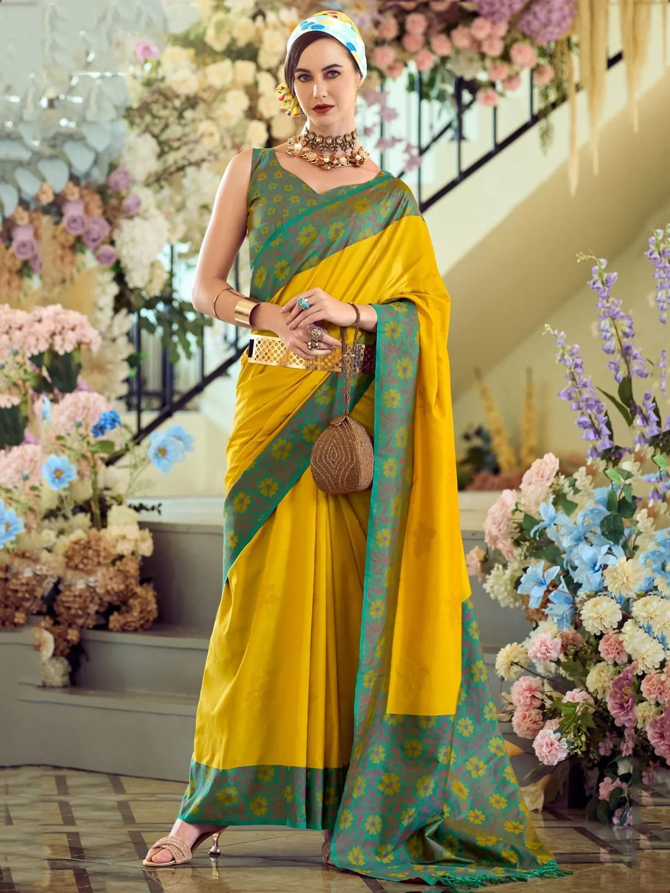 Yellow and green floral saree with matching blouse, styled with gold jewelry and floral headwrap for ethnic occasions