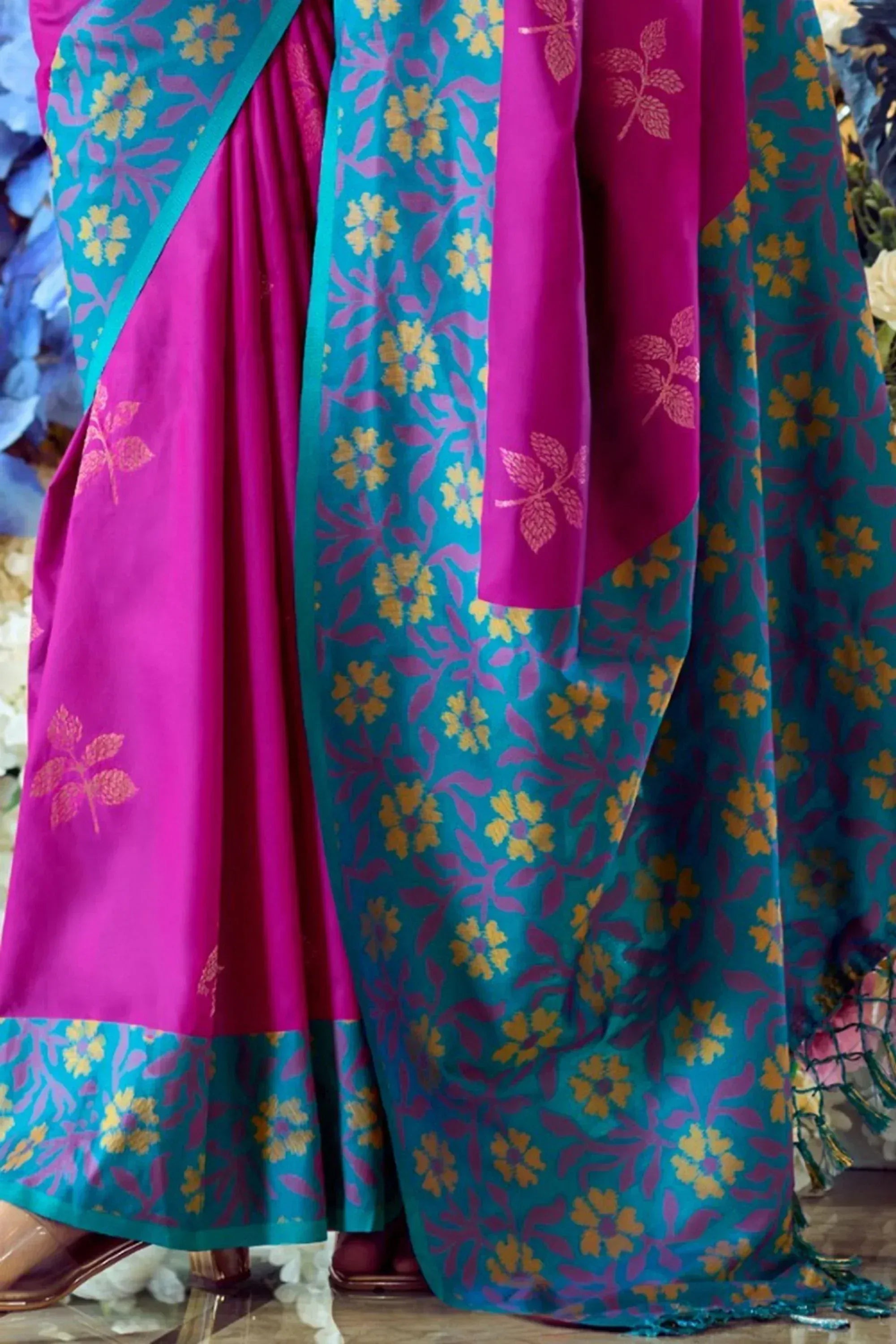 Vibrant pink and teal floral print Indian ethnic saree with golden motifs and border detailing