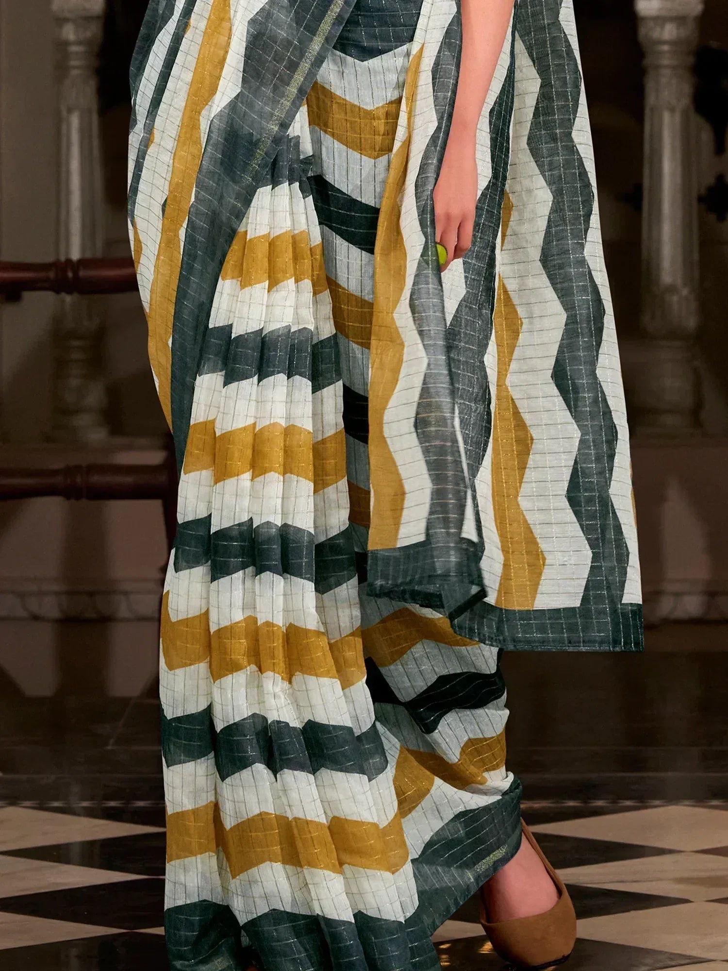 Stylish ethnic saree with geometric zigzag patterns in mustard, white, and teal, perfect for Indian wear.
