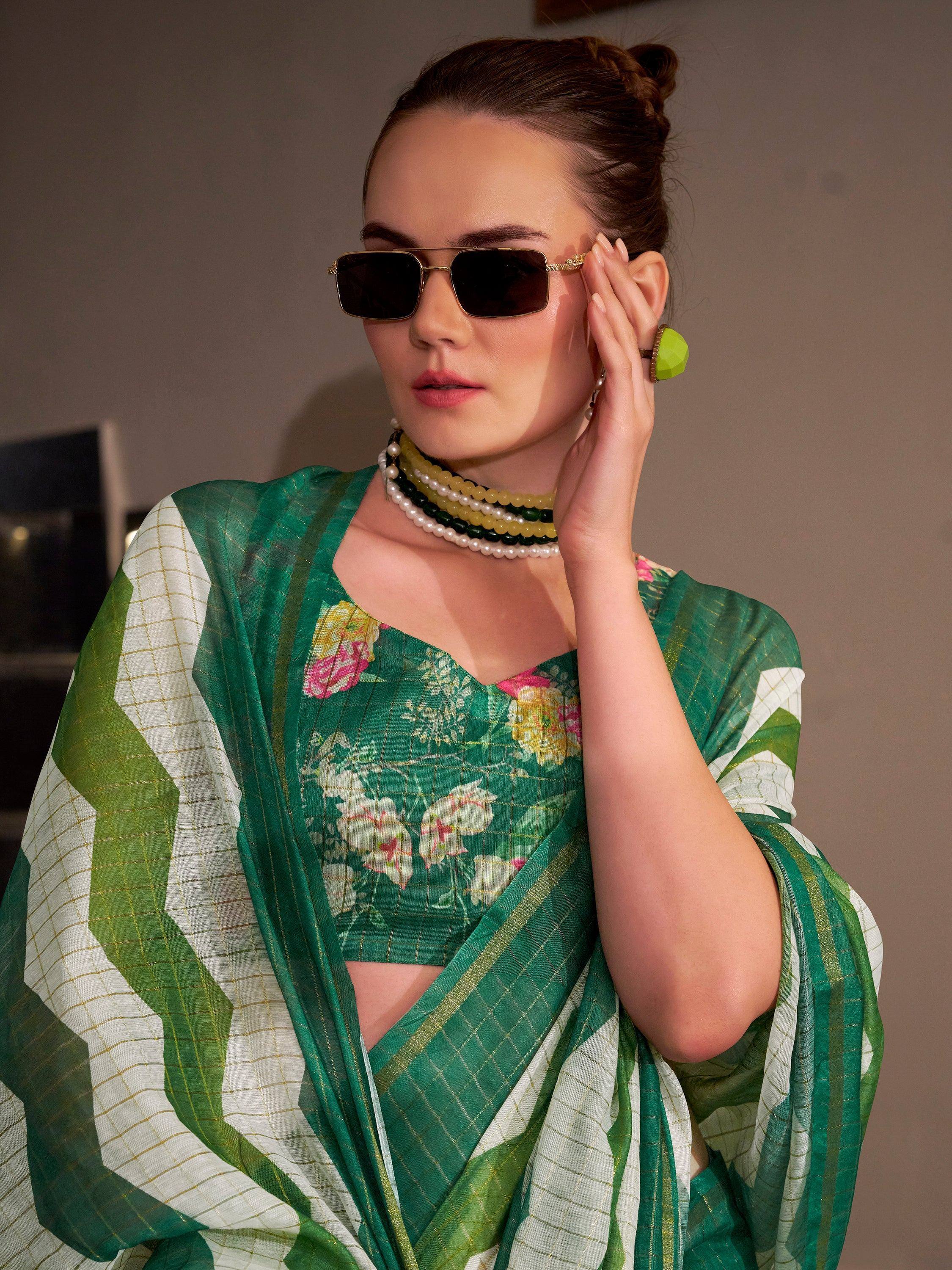 Green floral saree with gold accents, styled with sunglasses and pearl jewelry for a chic ethnic look.