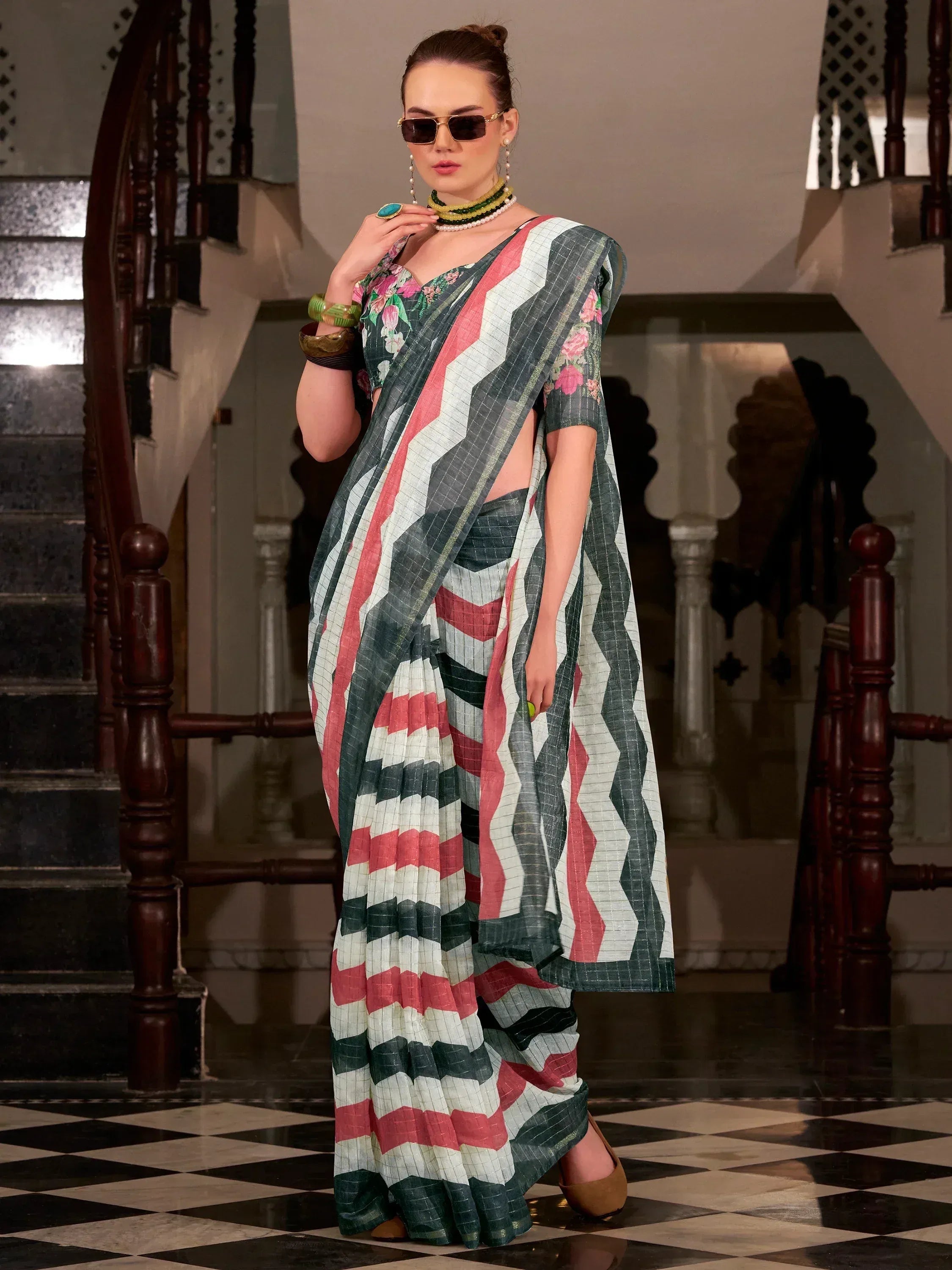 Stylish saree with geometric patterns and floral blouse, perfect for ethnic wear occasions.