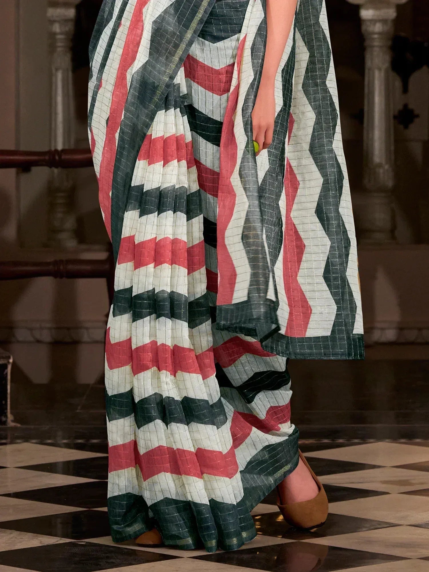 Stylish saree with red, white, and green geometric patterns, perfect for ethnic wear.