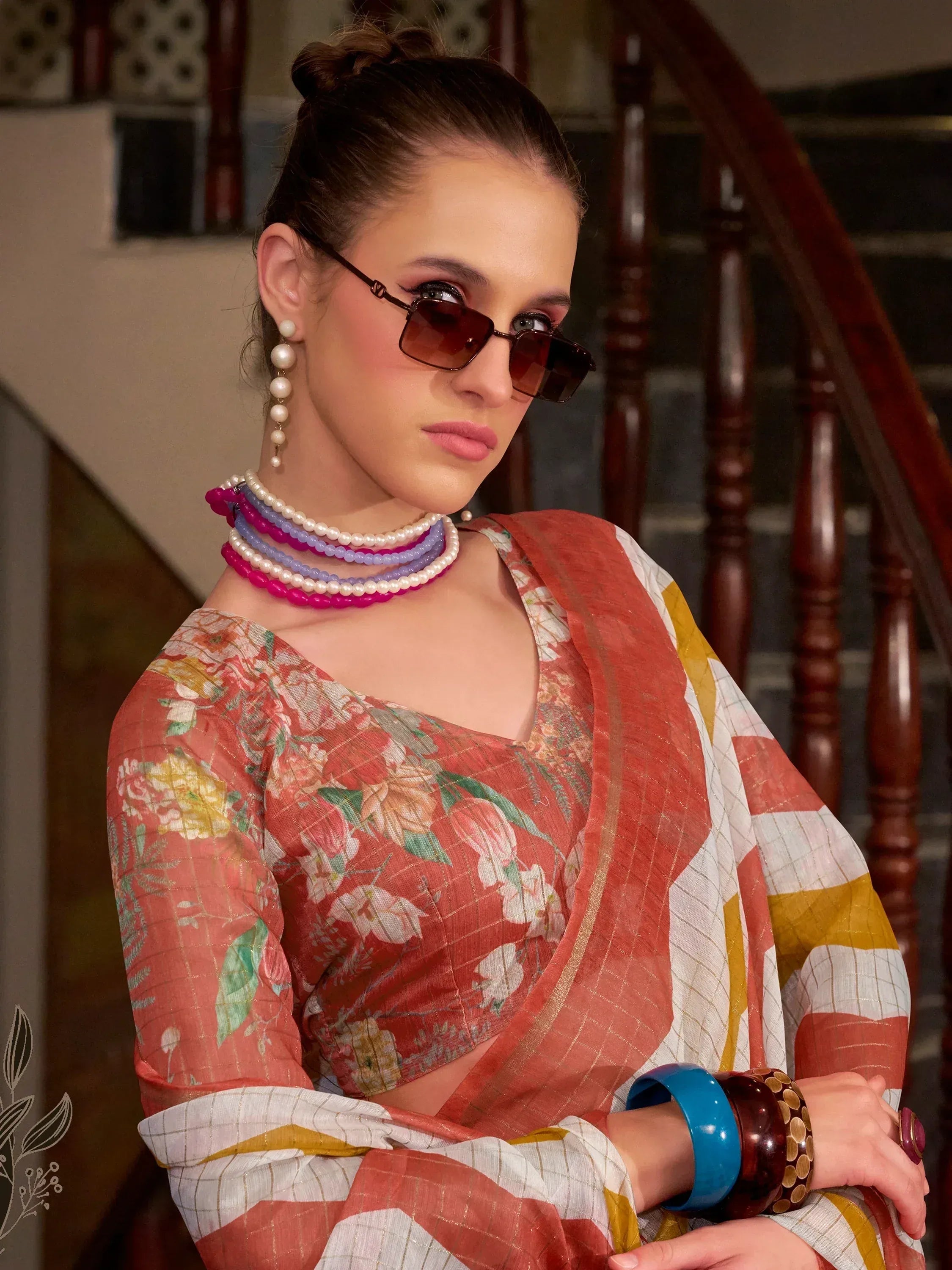 Floral printed ethnic saree with pearl necklaces and sunglasses