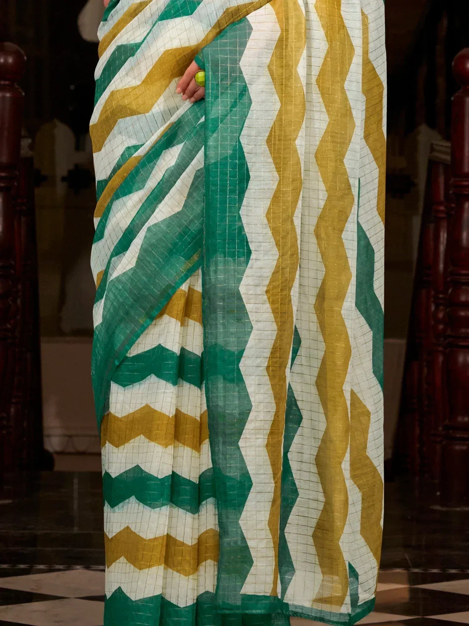 Green and yellow zigzag patterned saree with white base, styled for ethnic wear