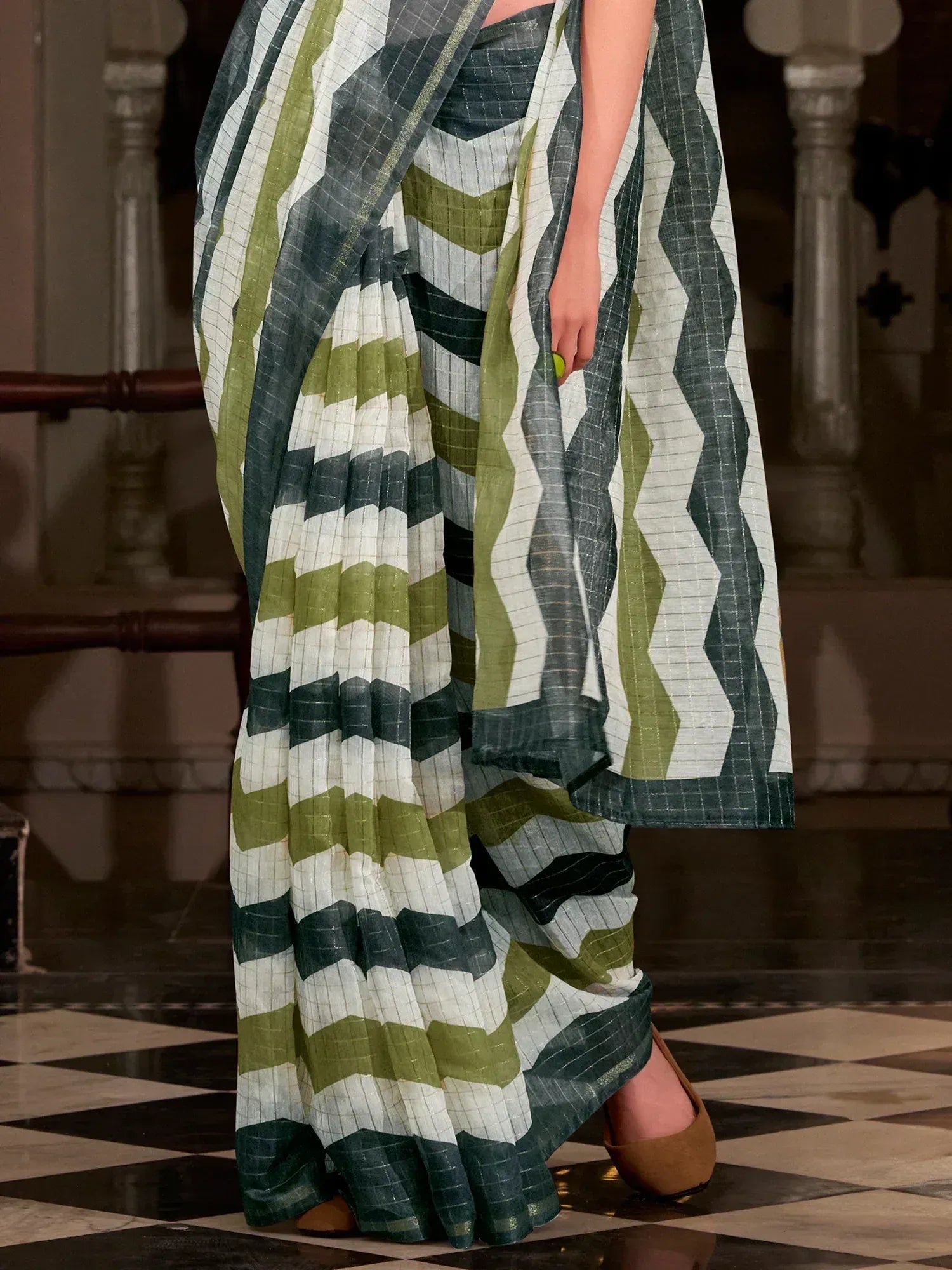 Green and white geometric patterned saree with elegant drape and checkered design