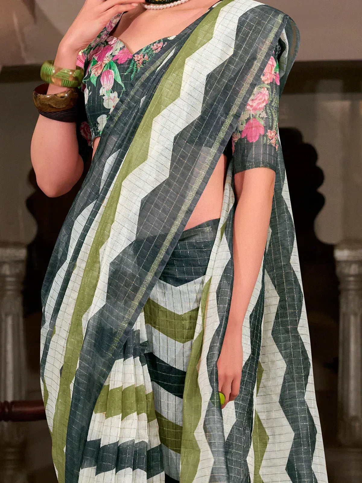Stylish green and white saree with floral blouse, perfect for ethnic wear occasions.