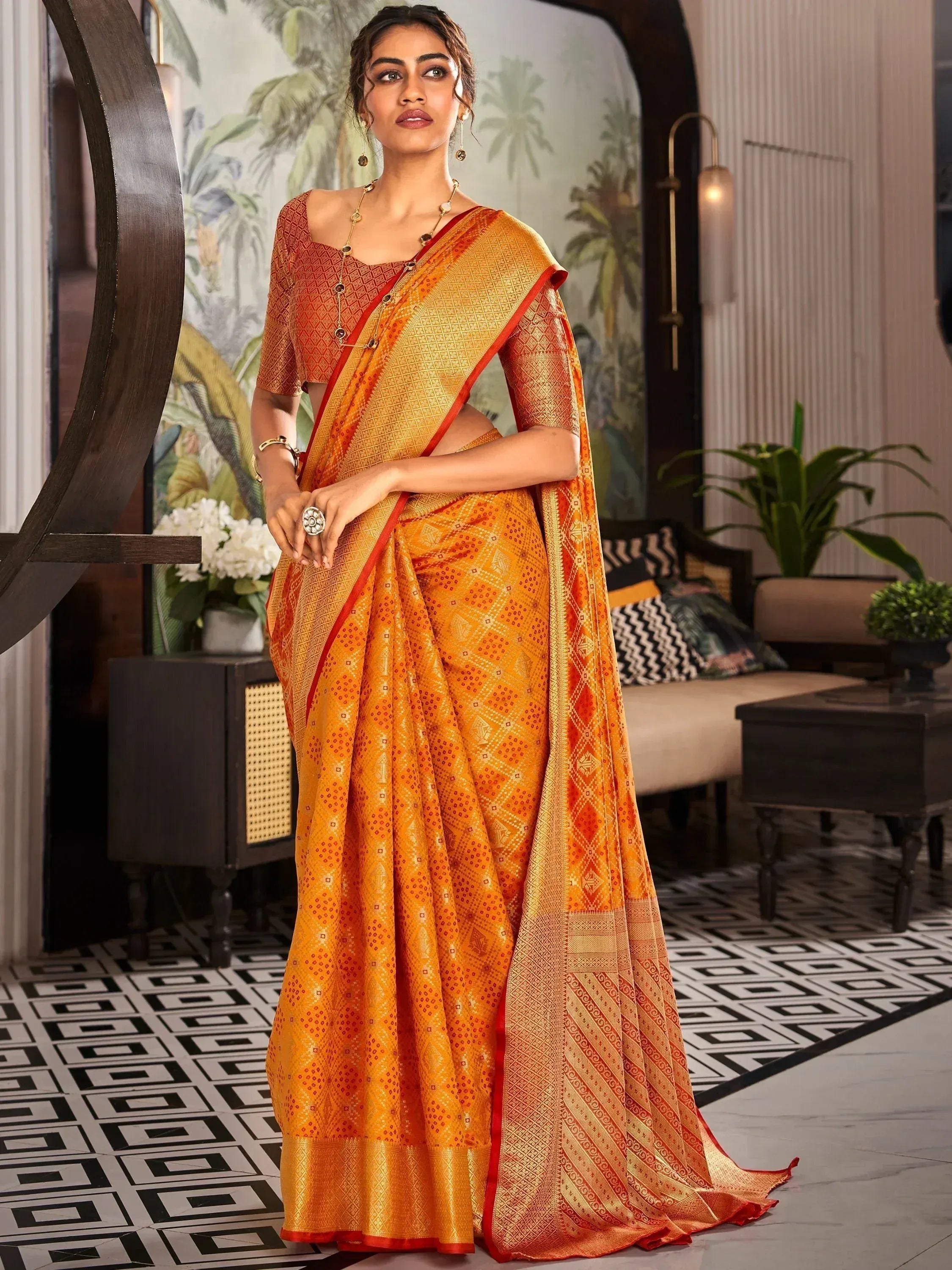Orange and gold designer saree with geometric patterns, perfect for Indian ethnic wear occasions
