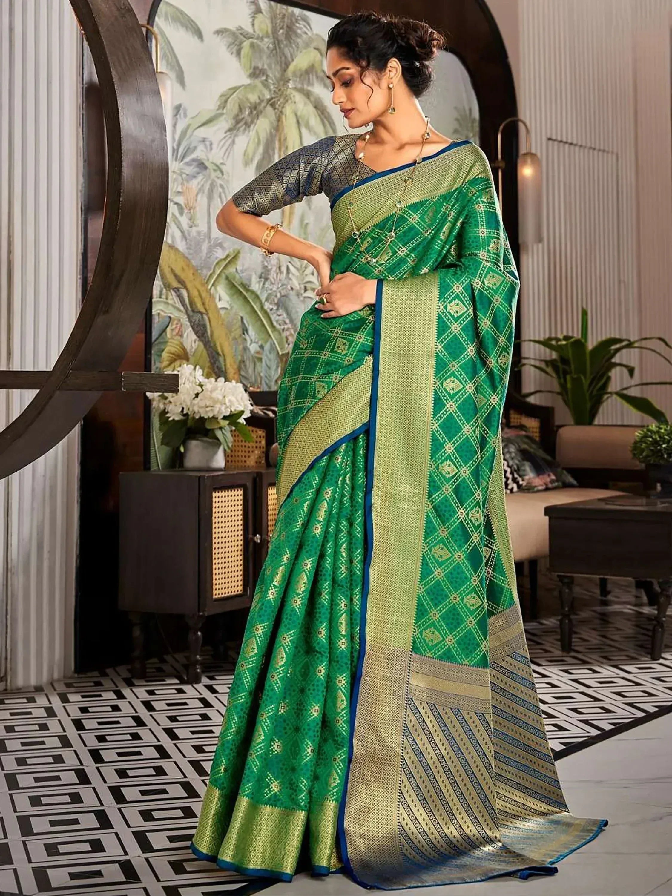 Elegant green and gold designer saree with intricate patterns, perfect for Indian ethnic wear occasions.