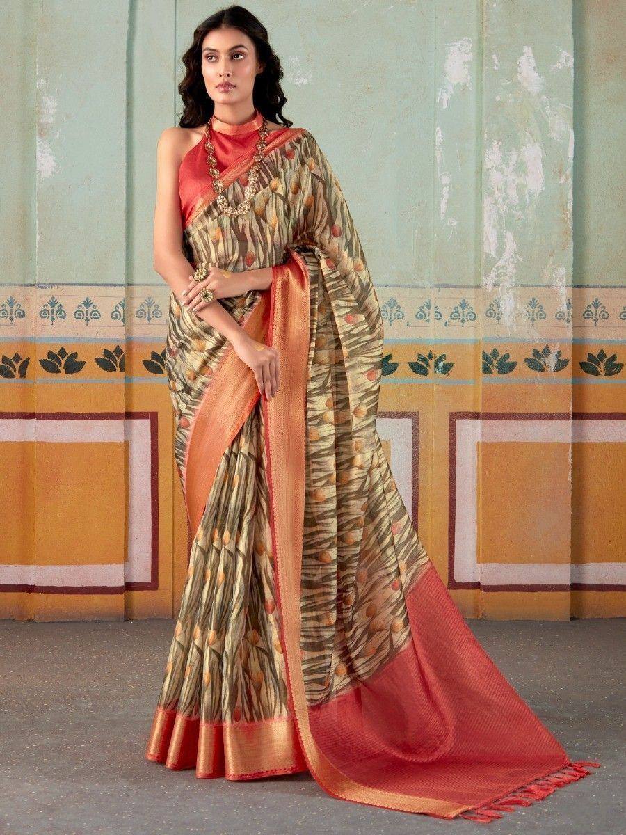 Elegant printed saree with orange border, paired with halter neck blouse, perfect for Indian ethnic occasions
