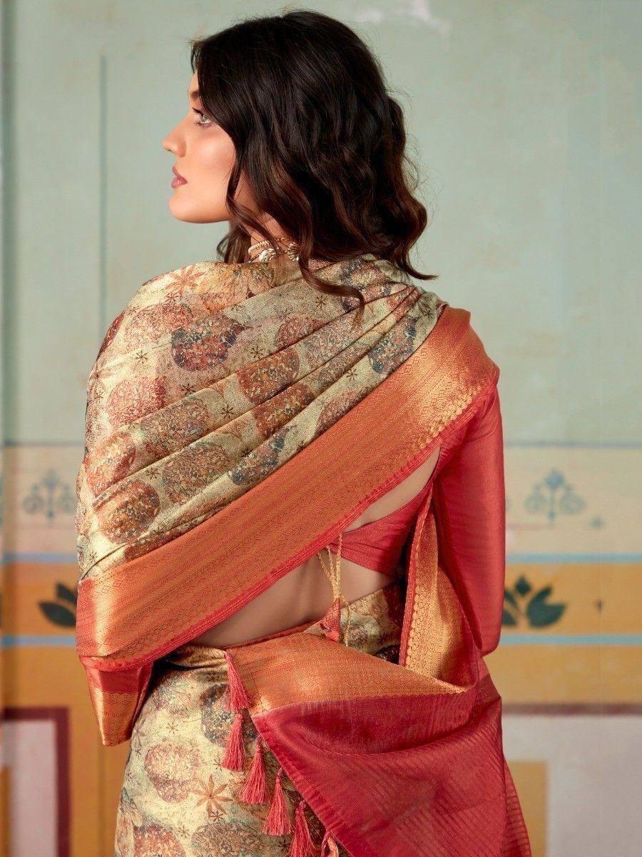 Elegant Indian saree with intricate paisley print and golden border, paired with a red blouse.