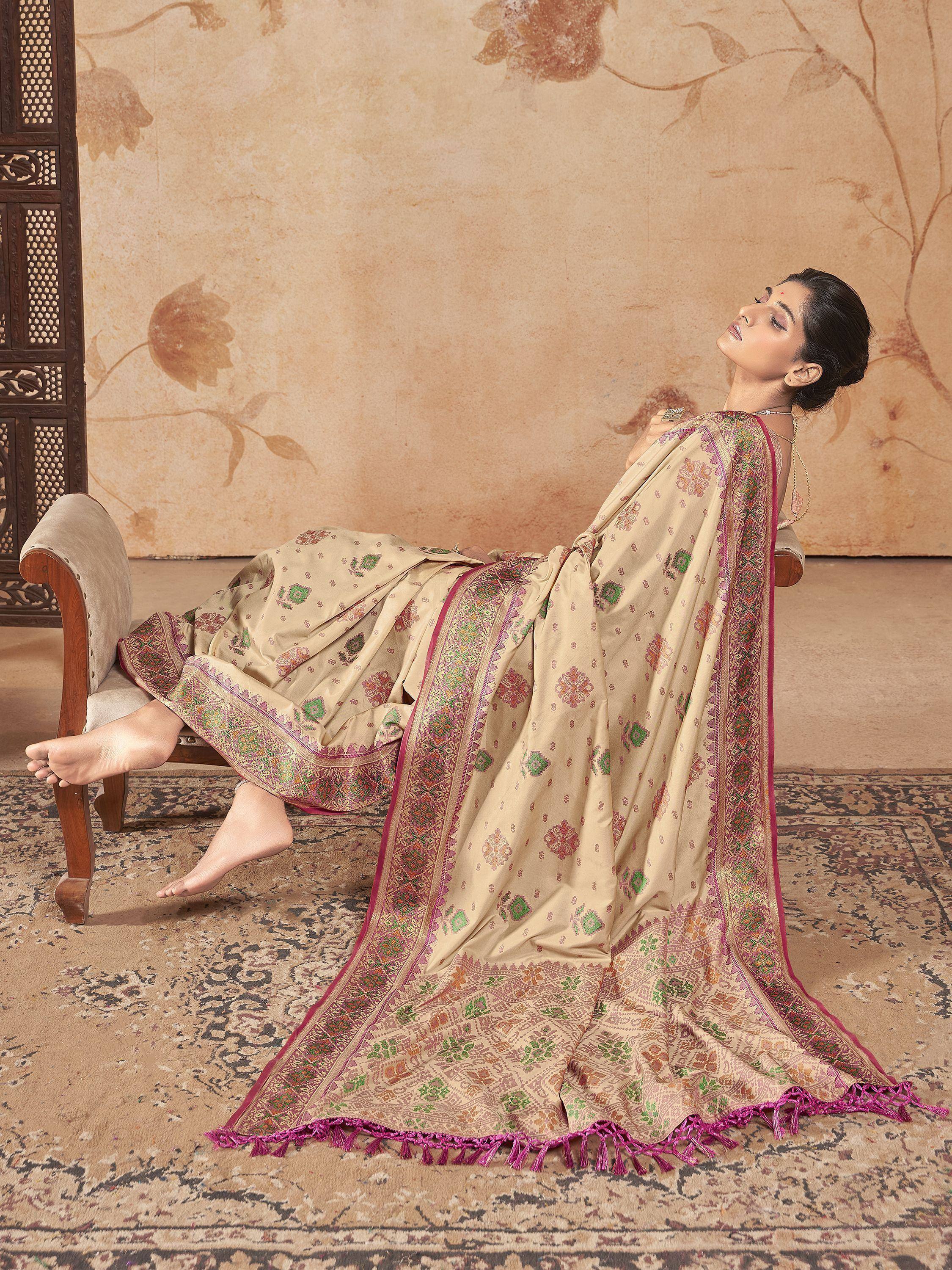 Beige floral saree with pink border and tassels, styled for ethnic wear