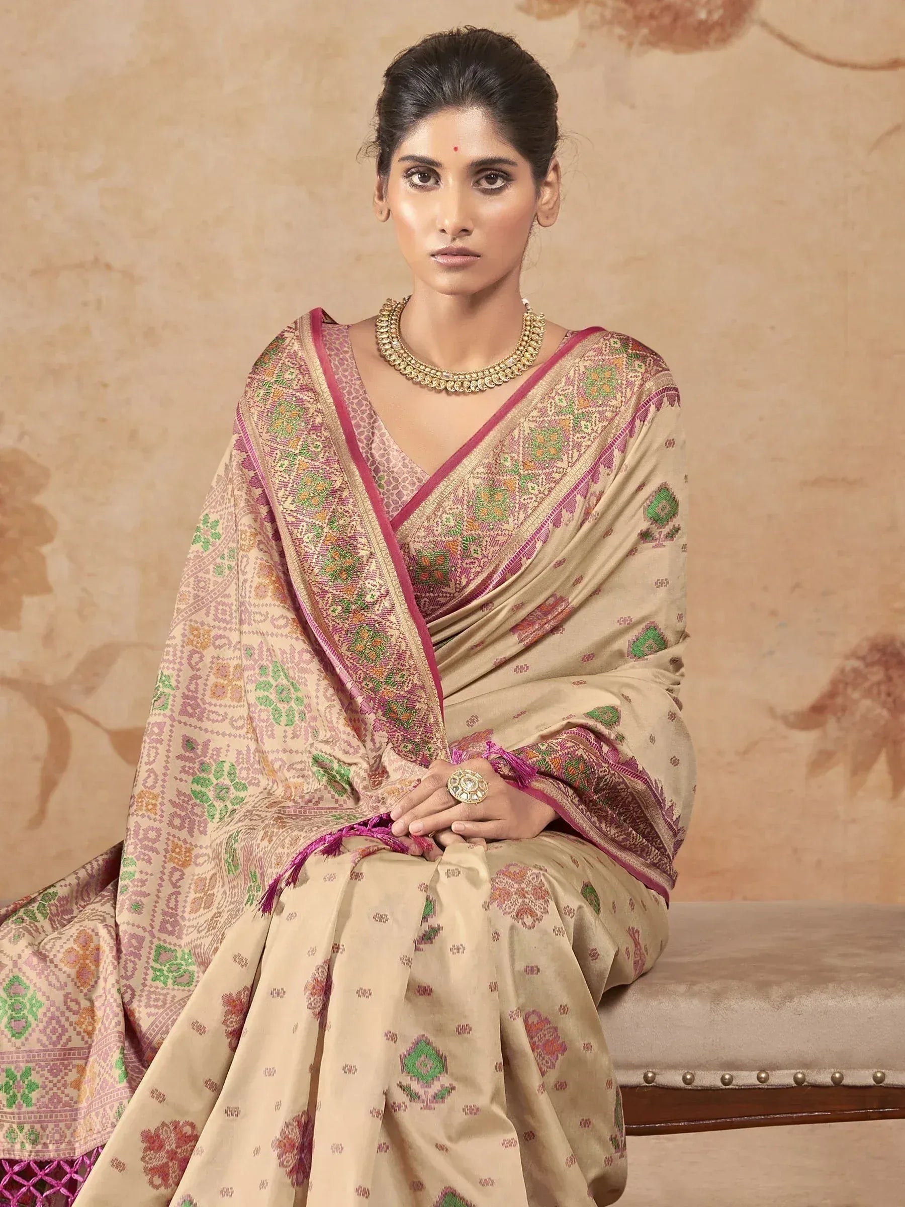 Elegant beige saree with pink and green floral motifs, perfect for Indian ethnic wear occasions