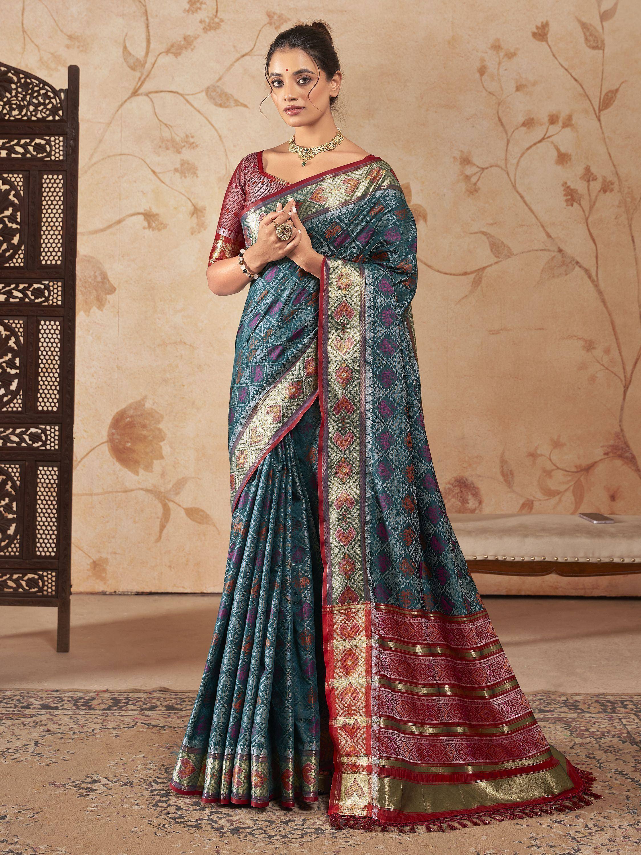 Teal and red designer saree with intricate geometric patterns and gold border, perfect for ethnic occasions