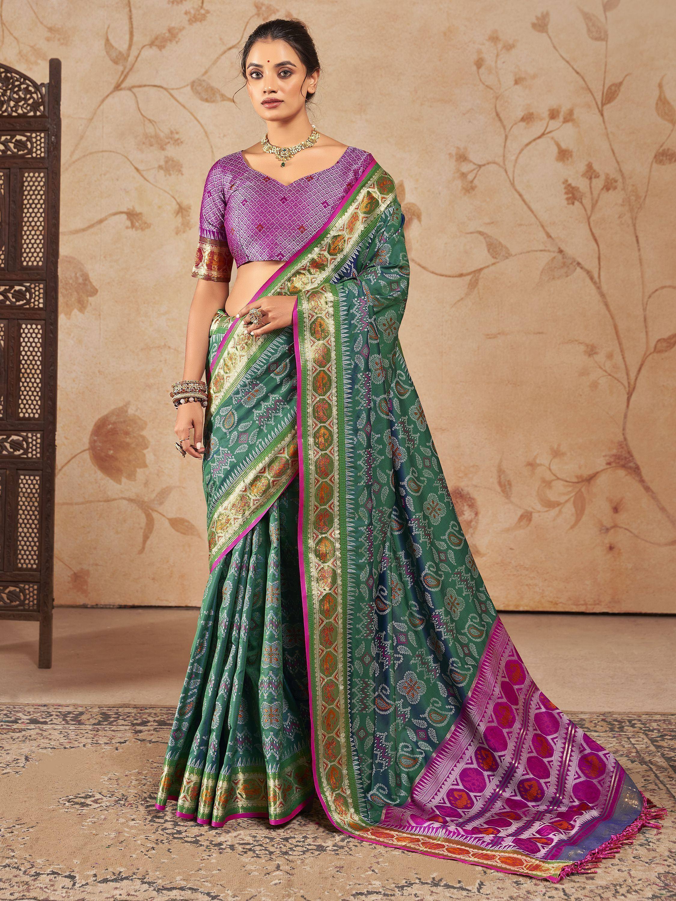 Green and purple designer saree with intricate patterns, perfect for ethnic wear and festive occasions.